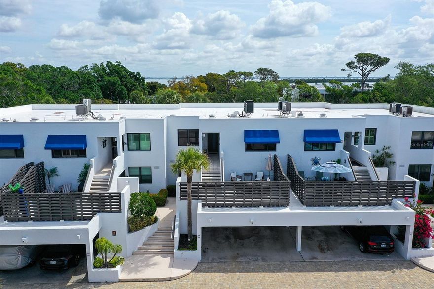 This stylish turnkey furnished beach retreat at Bayport Beach & Tennis Club is the perfect blend of classy with a modern flair. Before entering the home take note of the huge 16’ x 13’ outdoor deck where you can enjoy a partial view of the Gulf.  It's a great place to start your day with a cup of morning coffee, or enjoy a nice meal in the evening, and catch the spectacular colors of the sky as the sun sets!  Step inside to this inviting, beautifully appointed 2-bedroom 2-bath condominium with luxury vinyl flooring and crown molding throughout.  The entire living/ dining areas, lanai, both bedrooms and second bathroom have all been recently updated. Giving the condo a fresh polished appearance accentuated by recessed glass display shelving and an abundance of recessed lights.  The depth of workmanship in the updates carries onto the stylized door moldings into the primary bedroom.  All popcorn has been removed!  The kitchen offers a coffee bar, stainless steel appliances, a pantry, a nice arrangement of cabinets, and granite countertops open to the dining room and living room, perfect for entertaining. Take in the view of the lush tropical landscape and gorgeous pond right below the lanai that is open to the living room.  Perfect for a Murphy bed, extra living space, a reading nook or your second favorite spot for your morning coffee as the sun rises. The primary bedroom offers an additional 6’ by 6’ area that is perfect for an office desk looking out over nature.  The primary also offers a walk-in closet and a generously sized ensuite bath with dual vanities. Bayport Beach & Tennis Club is a gem with 27 tropical landscaped acres and 1200 feet of private Gulf waterfront deeded access.  Where you can grab a chair and umbrella and soak up the sun, or take in the breathtaking sunsets. Enjoy Sarasota Bay just outside your door and stroll to the private dock where you can fish, kayak, paddleboard, and watch for the manatees and dolphins as they cruise by. This community also offers a clubhouse, fitness center, 4 Har-Ter tennis courts, golf practice net, and a Junior-Olympic heated pool. Bayport Beach & Tennis Club consists of 17 buildings built between 1979 and 1983. Designed by architect Tim Seibert of the Sarasota School of Architecture. Located mid-key with a wealth of attractions moments away, including Bayfront Park, steps away, offering Pickle Ball, Basketball, Shuffleboard courts, playground, bike paths, kayak launch and Publix 2 miles away.