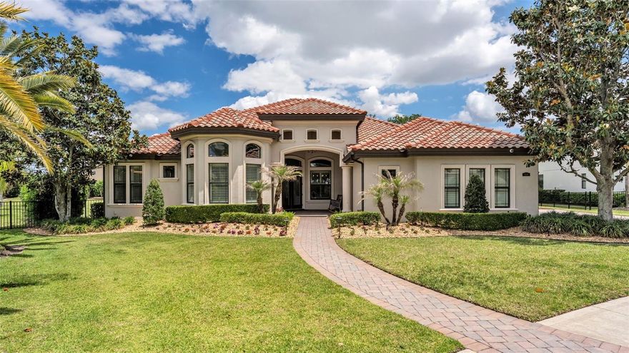 Welcome to 6538 Eagle View Loop, an exceptional 5-bedroom, 3-bath luxury pool home nestled within the gated golf community of Eaglebrooke in South Lakeland. With 24/7 guard-gated security, a championship golf course, clubhouse, resort-style pool, tennis courts, sidewalks throughout, and a vibrant clubhouse featuring a restaurant, bar, and weekly events, this community offers a true country club lifestyle with everyday convenience. From the moment you arrive, the home impresses with beautiful curb appeal, highlighted by a barrel tile roof, manicured landscaping, and a grand front entry with wood ceiling detail. Situated on a premium corner lot, one of the largest in the community, this fully upgraded, turn-key residence offers exceptional space, privacy, and seamless indoor-outdoor living. Inside, expansive windows and two triple sliding glass doors invite in natural light and open to a stunning pavered lanai, complete with a large heated inground pool, heated spa, and a fully customized and impressive outdoor kitchen featuring luxury stone countertops, stainless steel appliances, a commercial hood, and a gas fireplace. The backyard is equally impressive, offering lush buffered landscaping for privacy, a fire pit, and generous green space beyond the pool, perfect for relaxing or entertaining. The thoughtfully designed triple split floor plan provides both comfort and privacy, featuring a secluded primary suite with direct lanai access, a secondary bedroom wing, and a truly private in-law suite accessed through a separate hallway with a door from the main living area, complete with a bedroom, a large flex/media room ideal for a private living area, its own full bathroom, and direct access to the lanai. At the heart of the home, the chef’s kitchen is both functional and striking, featuring a waterfall granite island, farmhouse sink, under-cabinet lighting, double oven, gas cooktop, built-in wine fridge, and all-new appliances, flowing effortlessly into the main living areas overlooking the pool and backyard. Additional highlights include a front flex room with a gas fireplace, a glass-enclosed wine closet, marble-updated bathrooms with custom glass, plantation shutters, two-way sunshade blinds in the primary suite, and built-in closets. The laundry room is designed for convenience with a galley-style layout, offering a sink, countertops and cabinetry on both sides, an overflow refrigerator, a technology closet, and direct access to the side yard. Extensive upgrades from 2022–2025 include dual Carrier AC units with UV lighting, Brazilian tile flooring throughout, whole-home EcoWater filtration with reverse osmosis and alkaline filter, Ubiquiti WiFi, security cameras, MyQ garage system, epoxy polyaspartic garage flooring with wall organization, oversized washer and dryer, gas water heater, automated irrigation, trim lighting, and wood ceiling accents with in-ceiling speakers inside and out. Meticulously upgraded and thoughtfully designed, this home presents a rare opportunity to own one of the most refined, private, and feature-rich properties in Eaglebrooke.
