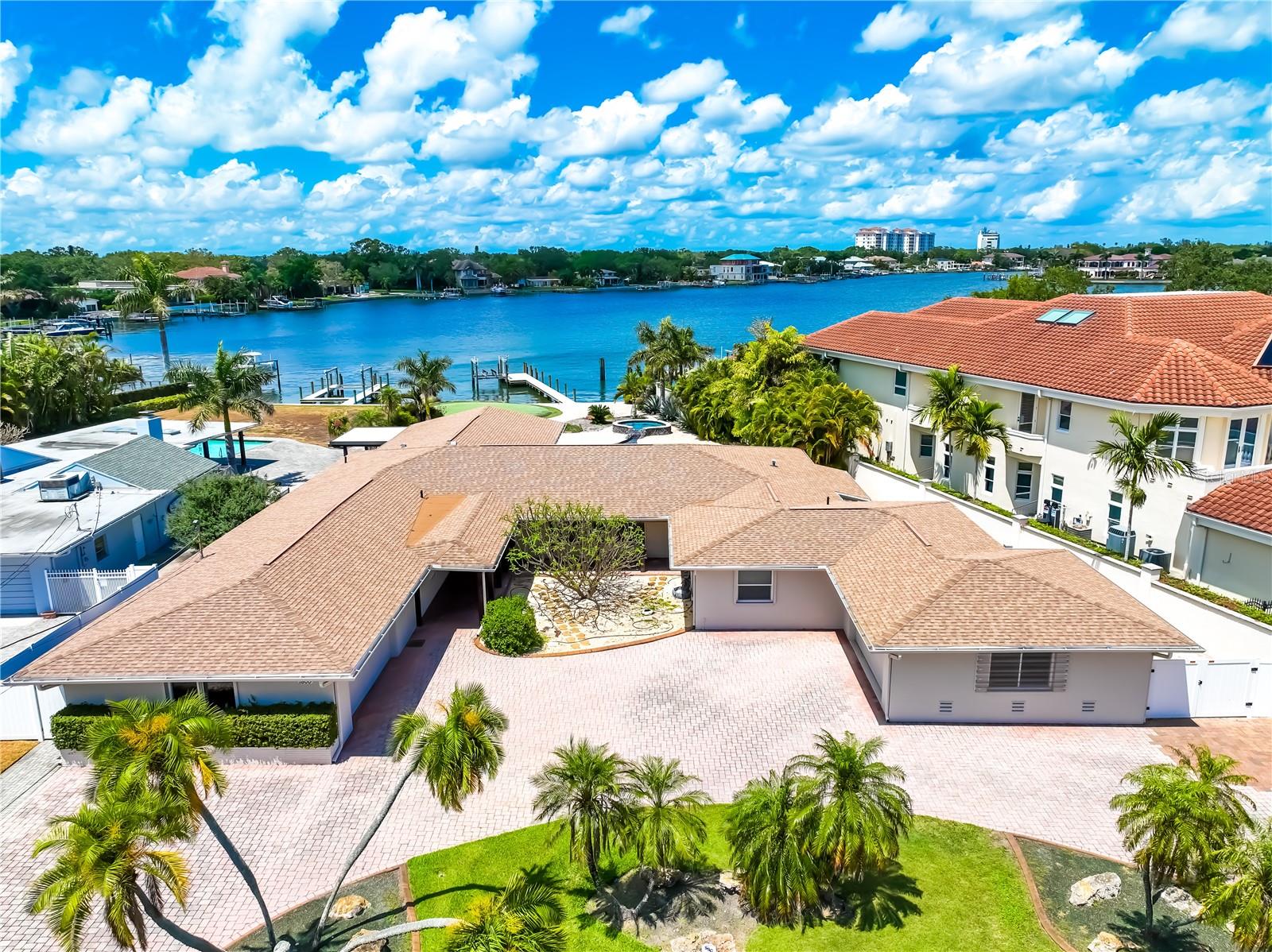 A TRULY ONCE IN A LIFETIME OPPORTUNITY to own one of the Gulf Coast's most sought-after addresses...BRIGHTWATERS BOULEVARD NE on SNELL ISLE in St. Petersburg. Its quiet and peaceful setting is mere minutes from one of America's most exciting downtown areas with its many shops, theaters, museums, yacht clubs, small airport, hotels, upscale restaurants and of course, the world famous newly rebuilt pier that juts deeply into Tampa Bay. The private Vinoy Country Club lies just down the street.
This beautiful 4500 square foot waterfront home features four large bedrooms, two and a half bathrooms, wood burning fireplace, covered outdoor entertainment area with its own heating system for cool nights, custom built swimming pool and spa, a circular drive with 4-car garage. The over half acre lot includes a synthetic golf putting green, NEW EXTENSIVE DOCK and a NEW ELECTRONIC BOAT LIFT, and NEW SEA WALL.
Snell Isle Harbor's water is clear and sandy bottomed and the property's shoreline is reinforced with a newly constructed and substantial seawall. Many boaters would consider is sheltered dockage, mere minutes from Tampa Bay.
The adjacent property at 105 Cordova Blvd NE is also for sale, providing the potential combination of both properties into nearly a full acre of Snell Isle estate-sized property and combining nearly 200 feet of shoreline waterfront.
We invite you to visit this remarkable site, drink in the vistas, breathe in the warm salt air and just....imagine! The potential is endless!
