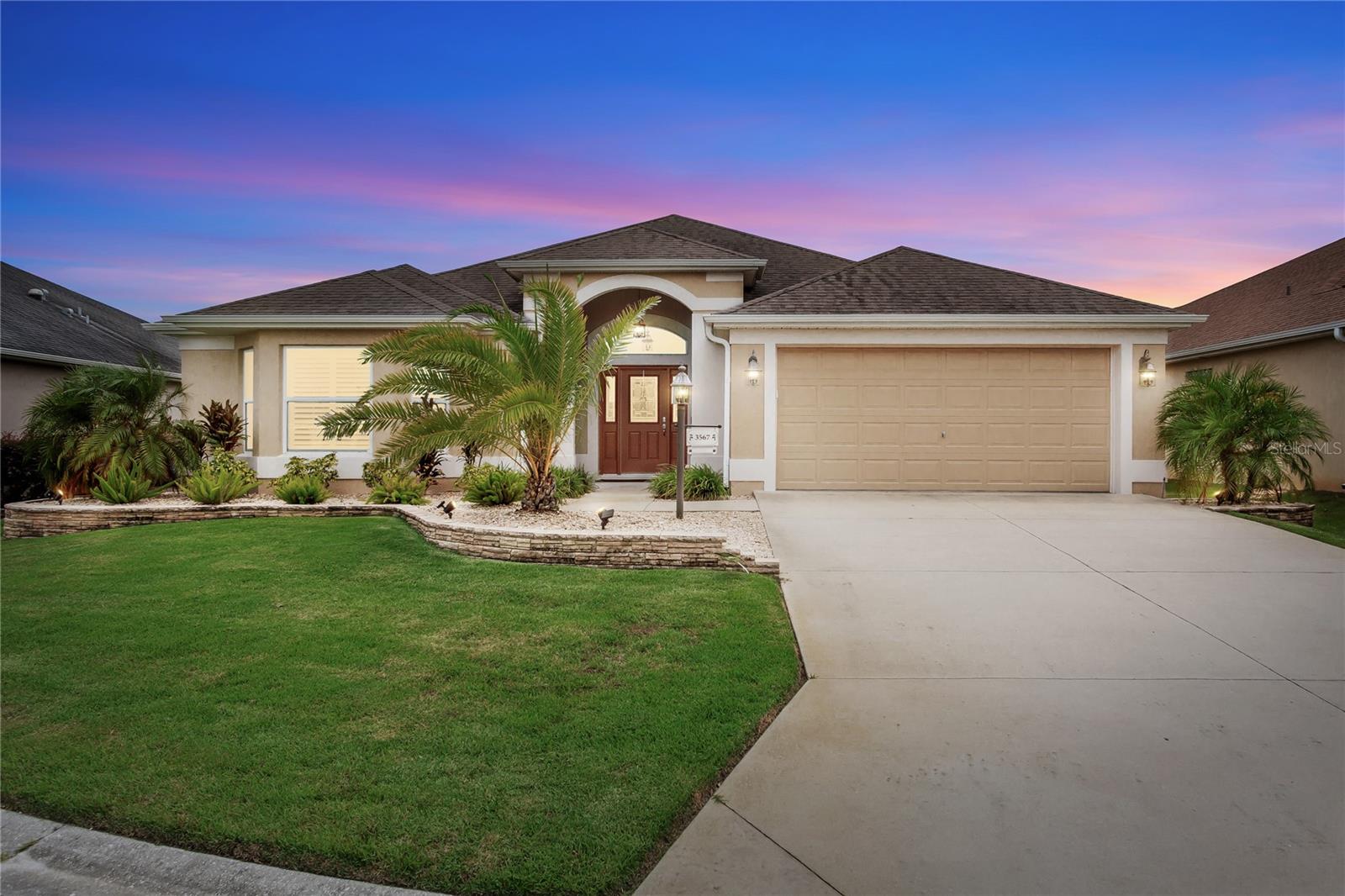 One or more photo(s) has been virtually staged. Stunning 3-Bedroom, 2-Bath Lantana in The Villages, FL - Pristine Condition & Prime Location! Welcome to this beautifully maintained Lantana floor plan, offering 3 bedrooms, 2 bathrooms, and an oversized (26 ft) 2-car garage with room for a golf cart. Nestled in a peaceful cul-de-sac just minutes from Brownwood Paddock Square, this home boasts the perfect combination of comfort, style, and convenience. Spacious Living: Large foyer entry sets the tone for this inviting home. Open and bright living spaces with updated flooring and fresh paint throughout. Upgraded ceiling fans complete the modern touches. Hiding sliders off the living and breakfast nook to the screened and private lanai. Updated Kitchen: Enjoy the gourmet kitchen with stainless steel appliances, granite countertops, maple cabinets with double rollouts, a breakfast bar, and a cozy breakfast nook. Elegant Touches: Plantation shutters and five solar tubes throughout the home bring natural light into every room, creating a warm and welcoming atmosphere. The glass inlay front door adds a touch of class. Luxurious Bathrooms: Main bathroom features a stunning Roman shower, dual vanity, plenty of cabinets and a private water closet. Main Bedroom: Large enough for a king-size bed along with two nightstands, dresser and any other type of furniture or seating. The main closet has custom built-in shelving. Two Guest Bedrooms and/or In-Law Suite: Spacious in size and with a tub/shower combination in the guest bathroom. Nice sized linen closet in the hallway. Living Room and Dining Room: Located off the kitchen for convenience with plenty of room for everyday living as well as entertaining guests or family. Relax & Entertain: Screened lanai along with a hot tub and a beautifully landscaped yard with lighted landscaping and rear privacy for outdoor enjoyment. Washer/dryer in utility room with cabinets overhead and utility tub. Upgraded Features: New blower for HVAC (under warranty), new garage door motor, and a painted garage floor. A year-old screen on the garage. Convenience & Comfort: Stucco exterior, ample storage space in this home along with pull down staircase for attic. Plus, the home is located close to all the activities and amenities at Brownwood Paddock Square. This home is move-in ready and waiting for you to enjoy the best of The Villages Florida’s lifestyle! Contact me today to schedule a private showing.