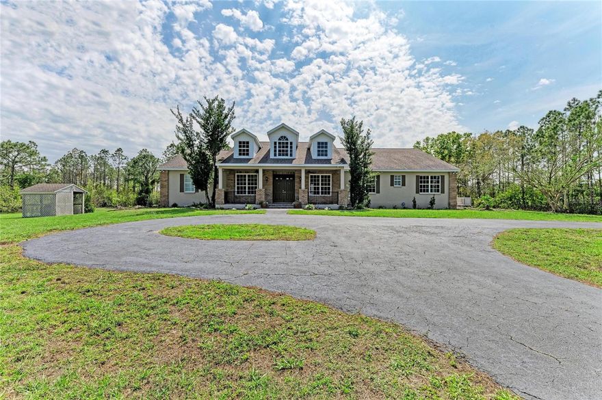 One or more photo(s) has been virtually staged. PRIVATE 10-ACRE ESTATE IN PANTHER RIDGE

This exceptional estate offers the ultimate in privacy and security, featuring its own private gate and a fully fenced 10-acre property. As you enter, a picturesque circular driveway and charming country-style front porch create a warm and inviting first impression.

Step through the double glass doors into a bright and elegant living room, where large French doors frame stunning views of the pool and outdoor living space. The formal dining room is beautifully accented with architectural arches, adding timeless character. A front-facing bedroom provides the perfect opportunity for a private office or guest suite.

The heart of the home is the spacious kitchen, designed for both functionality and entertaining. It opens seamlessly to the family room and features double wall ovens, a large custom pantry, a central island, and an expansive eat-in area surrounded by oversized windows. The family room boasts soaring ceilings and a gorgeous wood-burning fireplace, with French doors leading directly to the pool area for effortless indoor-outdoor living.

The primary suite is a peaceful retreat, complete with French doors, dual closets, and a spacious en-suite bathroom featuring a Jacuzzi tub, walk-in shower, and dual vanities. This home also offers a rare second primary suite on the main level, with its own private bathroom including a Jacuzzi tub and walk-in shower—ideal for multi-generational living or extended guests.

Additional living space includes multiple guest bedrooms, two upstairs bedrooms with a shared bathroom, and a large bonus room. A unique feature under the staircase includes a custom-built space designed to accommodate a 300-gallon aquarium.

Built with safety and resilience in mind, the home includes a reinforced concrete hurricane shelter with solid poured walls, a reinforced ceiling, and exterior locking doors. Additional features include hurricane-impact window film, a full security system with internet protocol cameras, and a commercial-grade Generac liquid-cooled QuietSource 25kW standby generator, supported by a 1,000-gallon propane tank—capable of powering the home for weeks.

The property also features a fenced dog run and is perfectly suited for animal lovers.

The 10-acre grounds are truly breathtaking, complete with a stocked pond for fishing and a large barn 30x 40. Located in the sought-after Panther Ridge community, residents enjoy access to scenic horse and walking trails. This equestrian-friendly neighborhood welcomes horses and chickens (no roosters), offering a true country lifestyle while remaining just minutes from shopping, dining, and everyday conveniences.