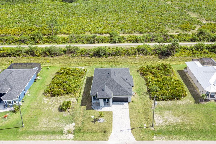 One or more photo(s) has been virtually staged. Seller is offering $5,000 toward buyer’s closing costs. Welcome to this stunning home in Rotonda Lakes, perfectly positioned next to the scenic Cape Haze Pioneer Bike Trail—ideal for biking, walking, and enjoying Florida’s natural beauty. Offering 1,894 sq ft under air, this thoughtfully designed residence features 3 spacious bedrooms, 2 modern bathrooms, and soaring 10-foot ceilings throughout, creating a bright and open ambiance. Built with impact hurricane windows for added safety and peace of mind, the home also showcases a paver driveway and lanai for an elegant touch. The gourmet kitchen is highlighted by sparkling black quartz countertops, ample cabinetry, and a large center island perfect for entertaining or everyday living. Pocket sliding doors fully open to the lanai, seamlessly blending indoor and outdoor living spaces. Conveniently located near trails, beaches, golf courses, shopping, and dining.  Don’t miss this incredible opportunity!