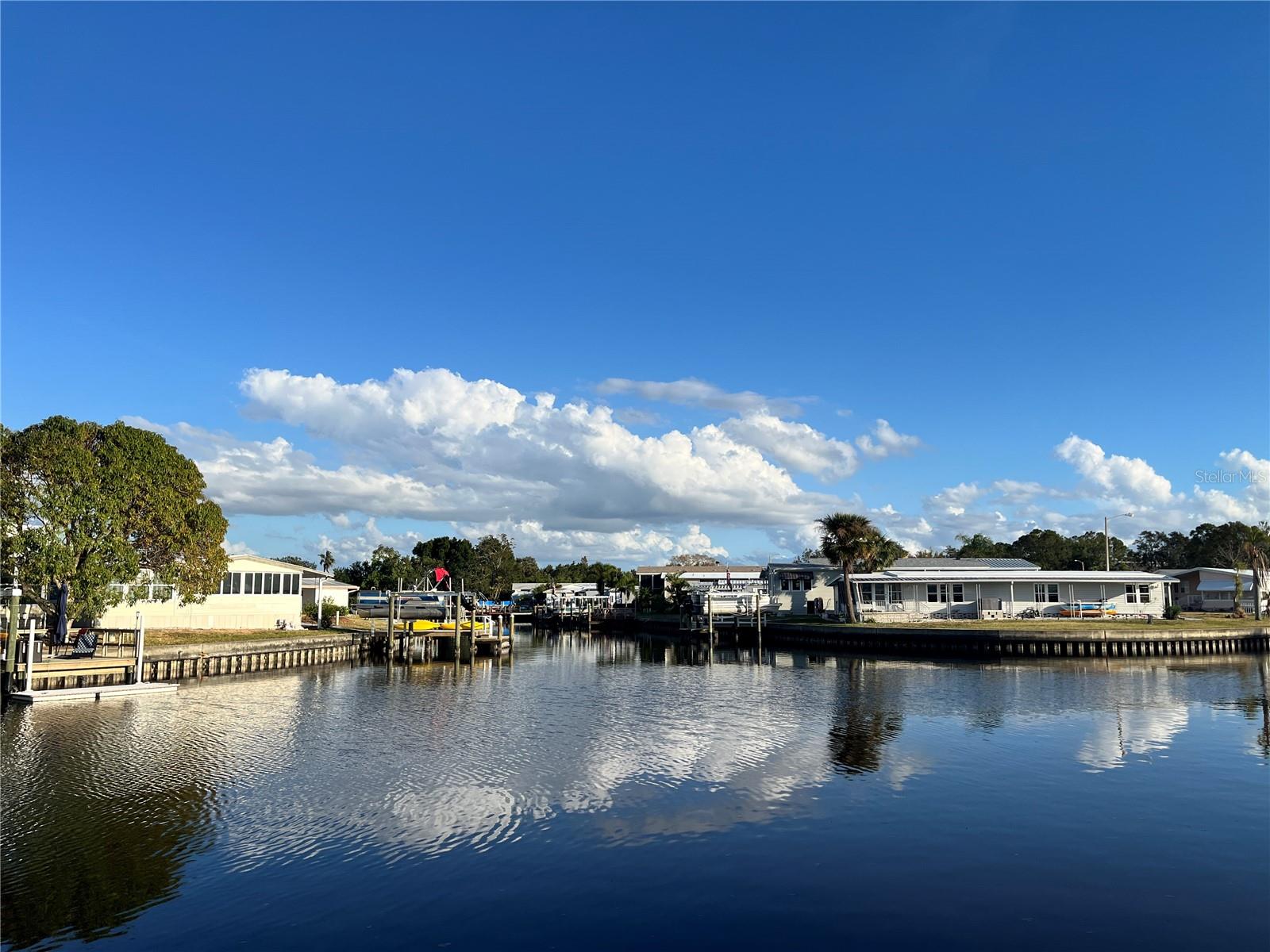 This 2 bedroom 2 bath coastal home comes with a dock and a lift, providing direct access to Tampa Bay. It is a perfect location for boaters, kayakers and fishermen, or anyone looking to spend time outside. Watch the dolphins and manatees while sitting on your dock, in your sunroom or your hot tub.
The home offers many updated amenities and a modern style. The kitchen remodel was completed in 2023 with all new cabinets, sink, granite countertops, and stainless steel appliances. A new AC was installed in 2022, and there are double-pane windows throughout.
All furniture, appliances, washer/dryer and hot tub are included in the sale price.
Price includes share for the lot and ownership in the co-op. Home is located in Americana Cove, a55+, resident owned, waterfront community only 10 minutes from downtown St. Pete, 20 minutes from two airports and 25 minutes to Gulf beaches. Low monthly fee of $380 includes 24 hour manned gate, private streets, water/sewer, lawn mowing/edging, trash pick up twice weekly and all amenities including heated pool, shuffleboard, bocce ball, two boat ramps and kayak launch, and a newly remodeled fitness room. And many clubs and activities to get involved in.