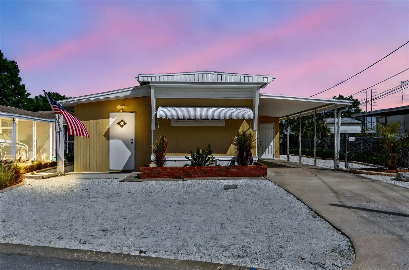 No interior flooding or damage during Hurricanes. Affordable Florida living without the fees — and with room to spread out. This updated 2-bedroom, 1-bath mobile home sits on a deeded lot in River Village with no HOA, no lot rent, and plenty of bonus space. Once inside, you’ll find an open layout with bamboo flooring, newer windows and doors, LED lighting, and a breakfast bar that connects the living space to the kitchen. The home also comes partially furnished and move-in ready. Two spacious bonus areas expand the home’s functionality: a 10’x20’ air-conditioned laundry/workshop with a new GE washer/dryer, water heater, work benches and storage — plus a 9’x30’ fitness room with AC and mounted TV. Major upgrades include a brand new $11K Daikin central AC system (installed 5/2024), updated ductwork, electrical panel and subfloor insulation. The lot is low-maintenance with xeriscaping, a covered carport, and private patio space — all nestled between US-19 and Alt-19 along the Anclote River. You're steps from the Pinellas Trail, just minutes to the World Famous Sponge Docks, and close to kayaking, fishing, and shopping. Own your land, skip the fees, and start enjoying Florida your way. Cash only.