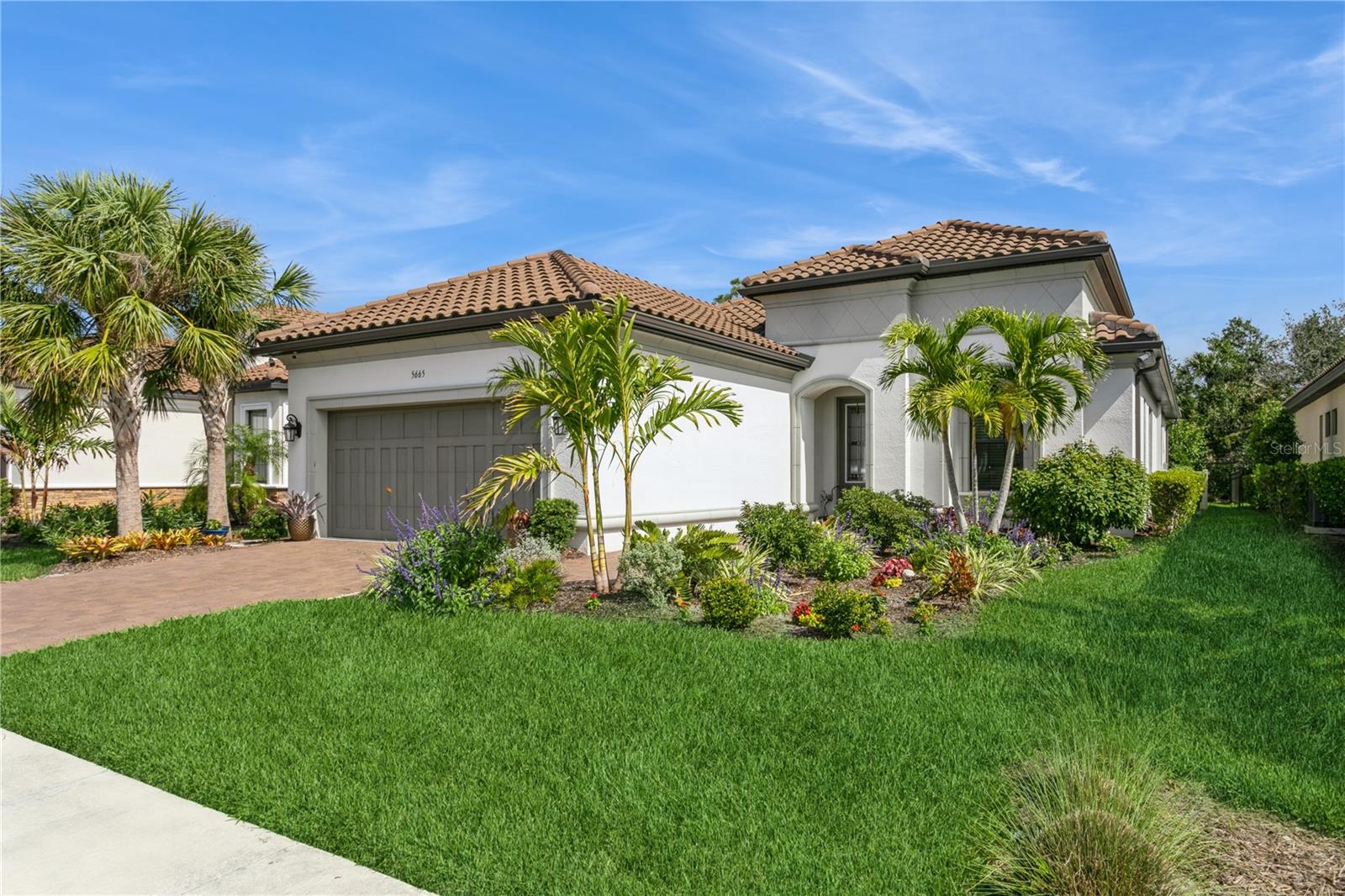 Welcome to this exquisite Taylor Morrison Farnese model home, nestled in the beautiful and serene community of Bellacina by Casey Key. Featuring 2 bedrooms, 2.5 bathrooms, a den, and a separate dining room, and includes IMPACT WINDOWS AND DOORS. This home offers a blend of luxury and functionality, perfect for modern living. As you step inside, you’ll be greeted by a grand foyer with tray ceilings and elegant crown molding, setting the tone for the rest of this immaculate home. The 24" x 24" polished porcelain tile flows throughout the entire home, adding a touch of sophistication and ease of maintenance. Silhouette window treatments enhance the beauty of each room while offering light control and privacy. The gourmet kitchen is a chef's dream, featuring a large kitchen island, stainless steel GE Café appliances, including a natural gas stove and a stunning GE Café refrigerator. Quartz countertops, a spacious kitchen nook, and abundant cabinetry make this kitchen both functional and stylish. The spacious living room is bathed in natural light, thanks to triple sliders leading to an expansive outdoor living area. The screened-in lanai offers a perfect retreat with plenty of space for dining and relaxing, while the gorgeous rectangular pool, complete with a waterfall feature and sun shelf, adds a luxurious touch. The area is also plumbed for an outdoor kitchen, making it an ideal spot for entertaining. The large primary suite, located at the back of the home, overlooks a peaceful preserve and boasts a spacious walk-in closet and a luxurious ensuite bathroom. The ensuite features a beautifully tiled walk-in shower, providing the ultimate retreat after a long day.
The second bedroom also has its own en-suite, providing privacy and comfort for guests. Additionally, the laundry room comes fully equipped with a washer, dryer, and ample cabinetry for extra storage. The extended garage is outfitted with durable epoxy flooring, offering both style and practicality. The home is located in a non-flood zone and has no CDD fees, adding even more appeal to this stunning property. Living in Bellacina by Casey Key offers more than just a beautiful home. Enjoy resort-style amenities including a sparkling community swimming pool with cabanas, a state-of-the-art clubhouse with a chef’s kitchen, a 24-hour fitness center, outdoor spa, and a cozy fire pit. There are walking trails, 4 pickleball courts, a tennis court, bocce courts, a playground, and 2 dog parks. A full calendar of events is organized by the on-sight Activities Director ensuring there’s always something to do and the full-time HOA manager is on-site as well. Location is key! Bellacina is only a 2.5 mi. golf-cart ride from Nokomis Beach, 5 miles from historic downtown Venice, 20 minutes to the world-renowned Siesta Key, and 30 minutes to downtown Sarasota and SRQ International Airport. This home is not just a gorgeous residence....it's a lifestyle!!