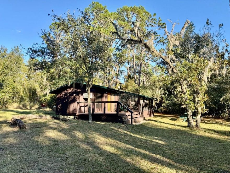 Recently updated 1/1 cabin located in recreational permit area on Lake Dorr. The cabin has a large updated kitchen with white cabinetry, quartz countertops, and new appliances. The bathroom has a walk-in tiled shower and a beautiful petrified wood sink sits atop the vanity. The bedroom can comfortably fit a queen bed with room to spare, has an A/C window unit, and a deep closet. Living room complete with French doors to screened porch, sliding glass doors to the open deck, and a cozy reading nook. Cat lover? Bring your furry companion along with you as they will enjoy the catwalks installed in the main living area with two cat doors. Has a full-sized stacked washer/dryer and a reverse cycle window unit in the living area. Enjoy picturesque views of Lake Dorr from the comfort of your screened porch or a BBQ on the open deck. For those chilly Florida nights, lounge around the fire pit to the tune of Kumbaya. Ample storage is provided in the detached storage shed. Has an outdoor shower, 2" well with pump house, and a newer drain field. Wiring in cabin was updated at the time of renovations (2022). Cabin is equipped with Starlink internet. The 130' dock at the water's edge is a fisherman's dream so grab your poles and get ready to cast a line! The Ocala National Forest covers 607 square miles, has six hundred lakes/ponds, miles of hiking/riding trails, and three first-magnitude springs.

***This cabin is situated on a 3/4 acre tract of government-owned land. No deed to the land will be issued. Selling interest in the cabin only. Buyer must apply for a special use recreational permit and acquire approval before the close of the cabin sale. Permits are issued for 20 years and must be renewed before its expiration. Cabin owners must abide by the rules and regulations set in place by US Forestry. Timeline for permit transfers is approximately one year out. Buyer(s) must submit an in-depth financial report to the Forestry service at the time application for permit is submitted.***