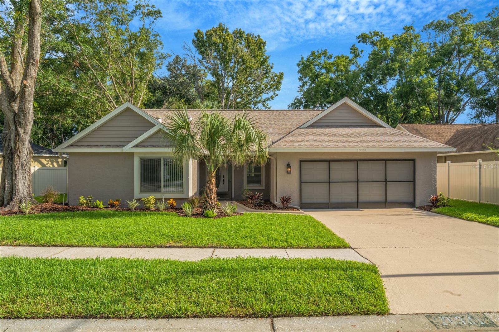 One or more photo(s) has been virtually staged. Welcome to this beautifully updated 3-bedroom, 2-bathroom home in the highly sought-after Woods of River Ridge—a community where homes rarely become available! Enjoy peace of mind with a new roof that is less than 1 year old. This home blends modern style with comfort featuring vaulted ceilings and brand new luxury vinyl flooring throughout. The spacious layout includes a stunning, completely remodeled kitchen, a large living room which is enhanced by skylights, creating a bright and airy atmosphere. The primary suite offers a large walk-in closet and tranquil pond views with no rear neighbors. There is also a generous bonus room off the primary suite—perfect for a home office, nursery, or flex space. The yard boasts fresh landscaping, and a serene setting complete with a koi pond and waterfall feature. Located in a top-rated school zone (River Ridge Middle & High), this home offers both privacy and convenience with an easy commute to anywhere in the Tampa Bay area. With low annual HOA dues, natural beauty, and thoughtful, new upgrades throughout, this is a rare opportunity you don’t want to miss!
