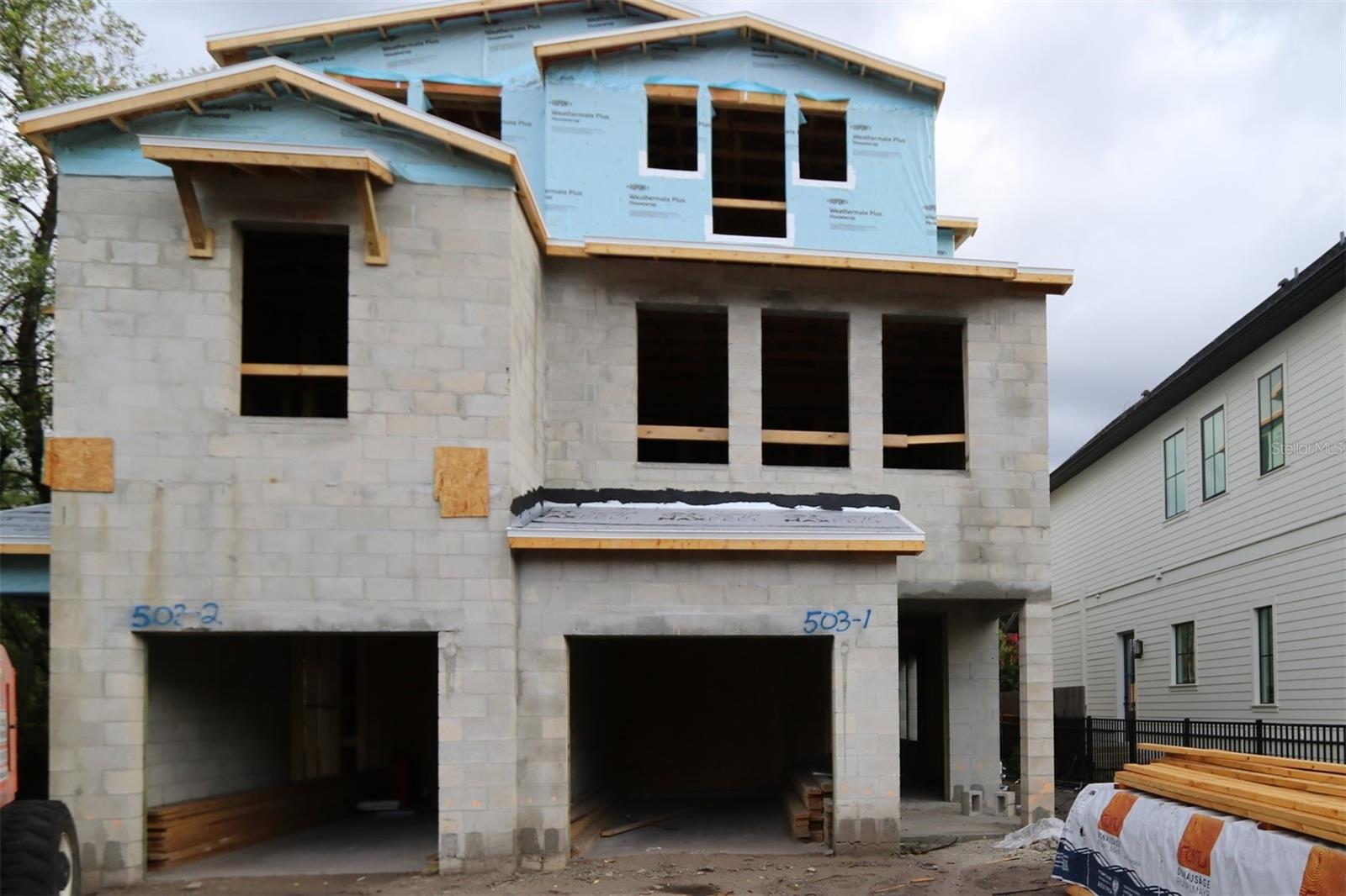 Under Construction. Welcome to this stunning, 3-story townhome in The Heights! Minutes to Armature Works, Riverwalk and don’t forget the brand-new Publix!
The exterior boasts tremendous curb appeal with a mix of Hardie plank siding, stucco, and stone detailing, setting the stage for the gorgeous interior. This fee-simple ownership townhome has no HOA fees, giving you more freedom and flexibility. Included is a 25ft deep, fenced in back yard to allow great outdoor living space. Inside, the design team has truly outdone themselves, blending natural maple tones with white and cream hues throughout. The standout kitchen is a dream with a large single bowl granite composite sink, herringbone backsplash, quartz countertops, and an open floor plan perfect for family gatherings.
The second floor features an oversized primary suite with 3 large windows that flood the room with natural light, a walk-in closet, and a convenient door leading directly to the laundry room. An additional en-suite on the opposite side of the floor offers privacy and comfort for guests or family members. Natural light fills the stairwells, which are adorned with oversized windows and sleek rev-wood laminate flooring that extends throughout the home.
The third floor is designed with versatility in mind, featuring 2 separate bedrooms, a bonus room, and a full bath—perfect for a home office, playroom, gym or guest space.
This home also comes with a list of impressive extras, including impact glass windows and doors, no flood insurance required, gutters, and a refrigerator included. Plus, the home is backed by the trusted reputation of David Weekley Homes and a comprehensive builder's warranty, making it a smart, worry-free investment. We can’t wait to show it to you! Please note, photos and virtual tours are of a similar completed “Tanglewild” home for reference and may include options or features no longer available.