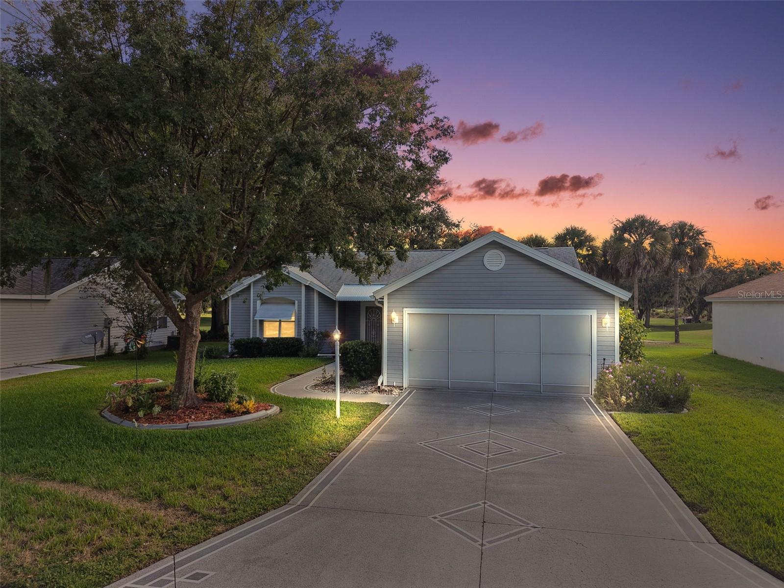 ENJOY BREATHTAKING, PANORAMIC, WATER and GOLF FRONT VIEWS in this 2/2 DESIGNER Coronada CONVENIENTLY LOCATED in the village of Mira Mesa! Just minutes to CR 466 and Hwy 441/27 as well as Spanish Springs Town Square with shopping, dining, and nightly entertainment! BOND PAID! DECORATIVE PAINTED drive and walkways, curbed landscape, covered entry, and front door with side lite and transom window welcome you in to this GENEROUS foyer boasting an ENTRY CLOSET! The SPACIOUS living room features VAULTED ceilings, TILE flooring, artistic DISPLAY NICHES, and TRIPLE windows overlooking the GORGEOUS WATER and GOLF FRONT VIEWS! The adjacent dining room boasts a VAULTED ceiling and RICH, WOOD-GRAIN LAMINATE flooring. The AMAZING kitchen features BEAUTIFUL WOOD cabinetry with PULL-OUTS, DOUBLE BULT-IN PANTRY, EAT-IN breakfast bar, VAULTED ceiling, VINYL flooring, and adjacent DINETTE area. Just off of the dinette area , you will find one of the home’s prime highlights . . . the SPECTACULAR FLORIDA ROOM which adds approximately 240sf of under-air living space to this fabulous home! This wonderful room offers PICTURESQUE WATER and GOLF FRONT SCENERY and features TILE flooring, VAULTED ceilings, an ABUNDANCE of large windows that fill the space with natural light, and an exterior door that opens to the screened lanai - the perfect spot to sip your morning coffee or SIMPLY ENJOY the fresh Florida air! Retreat to the primary bedroom, where you'll find RICH WOOD laminate flooring, VAULTED ceiling, LARGE WALK-IN closet., and TWO windows BOASTING PEACEFUL WATER and GOLF FRONT VIEWS! Its en-suite bathroom features TILE flooring, VAULTED ceiling, WOOD cabinetry, TILED WALK-IN shower, and a separate water closet. Bedroom two has DOUBLE windows, RICH WOOD laminate floors, and a built-in closet, The second bathroom features TILE floors, WOOD cabinetry, TILED tub and shower combination with glass doors, SOLAR TUBE, and a hallway LINEN closet. The 2-car garage offers an EPOXIED floor, SLIDING garage door SCREENS utility sink, shelving, and attic access with stairs DON'T MISS YOUR OPPORTUNITY TO MAKE THIS INCREDIBLE WATER and GOLF FRONT VIEW HOME YOUR OWN! The village of Mira Mesa is conveniently located between Spanish Springs Town Square and Lake Sumter Landing; Close to Tierra Del Sol Country Club and Championship Golf Course; Mira Mesa Executive Golf Course; Hacienda Regional Recreation Center; Chula Vista Recreation Center; multiple pools, golf, and pickle ball; The Villages Regional Hospital; and 466 with an abundance of shopping, restaurants, banks, medical, and more! PLEASE WATCH OUR WALKTHROUGH VIDEO OF THIS FANTASTIC HOME and call today to schedule your Private Showing or Virtual Tour