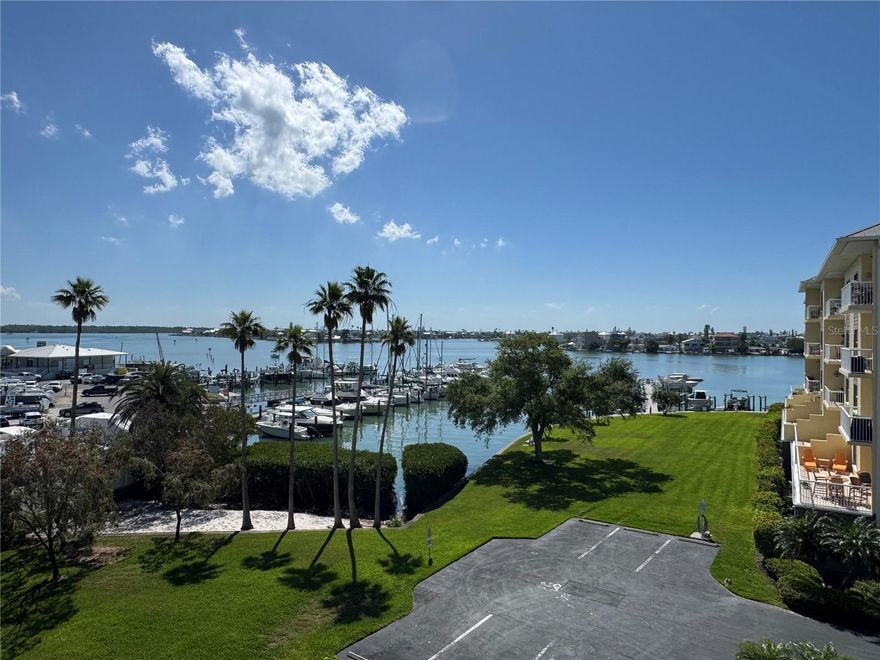 EXCLUSIVE MADEIRA BEACH AND BOATER RETREAT

Discover elevated waterfront elegance in this rarely offered 2-bedroom, 2-bath condo with an on-site private garage and the ability to purchase or rent your own boat slip!!  Perched high for panoramic vistas of scenic intercostal waterway, the expansive covered patio becomes your private outdoor haven—perfect for morning coffee with dolphin sightings or sunset cocktails overlooking the water. Step inside to an inviting open-concept layout with high ceilings with elegant crown molding. The gourmet kitchen shines with stainless-steel appliances, granite countertops, reverse osmosis filtration, and a whole-home water softener system. Newly installed tile floors with sound-dampening underlay throughout the unit ensuring quiet comfort. The generous primary suite features intercostal  views, dual walk-in closets, a spa-like en-suite bath with double vanities, and easy access to the patio for that morning stretch or evening unwind. A split floor plan keeps the guest bedroom and full bath private and convenient, ideal for visitors or family. Inside laundry adds everyday ease after beach days or time on the water. Plus, an oversized private garage for secure parking, and pet-friendly policies. Community perks include a heated pool and spa for year-round relaxation, a well-appointed clubhouse with kitchen for gatherings, lush tropical grounds, kayak launch, and recent building enhancements (fresh exterior paint, plumbing upgrades, and a clean structural milestone inspection—no major issues noted). You're just steps from pristine Madeira Beach sands, eclectic shops, waterfront dining, grocery stores, pubs, and surf spots. Quick drives to vibrant downtown St. Pete (20 minutes) or Tampa International Airport (45 minutes) keep you connected without sacrificing that laid-back beach vibe.