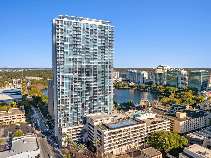 Nestled in the heart of Downtown Orlando, this stunning loft-style condo offers striking views of Lake Eola and an unparalleled urban lifestyle. Featuring an open-concept design, this modern space is adorned with large fine Italian ceramic tile flooring throughout the first level, creating a seamless and sophisticated look. A dramatic spiral staircase leads to the spacious lofted master suite, which boasts a deep walk-in closet for ample storage. The floor-to-ceiling windows flood the unit with natural light, showcasing the breathtaking cityscape and vibrant Lake Eola views. Enjoy the convenience of in-unit washer and dryer, which convey with the condo, making laundry day a breeze. This exclusive residence includes one assigned parking space with EV charging access, as well as guest valet parking for added convenience. Located in one of Orlando’s most sought-after high-rises, you’ll have access to premium building amenities and be just steps away from fine dining, entertainment, and everything Downtown Orlando has to offer. Don’t miss this rare opportunity to own a sophisticated urban retreat in the heart of the city! With its prime location, you’ll be within walking distance of Orlando’s best dining, entertainment, and cultural hotspots, as well as the scenic Lake Eola Park. Don’t miss the opportunity to experience urban luxury at its finest—schedule your private tour of 150 E Robinson St #1007 today!