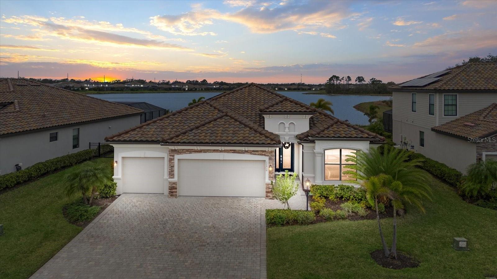 Experience the ultimate backyard paradise in this 4-bedroom, 2-bath home in Polo Run, Lakewood Ranch’s only solar-powered gated community. Spanning 2,268 sq. ft., this home seamlessly blends modern elegance with eco-friendly living—but it’s the outdoor space that truly steals the show.
Step outside to your private resort-style oasis, where a custom saltwater pool glistens against the backdrop of one of the largest lakes in Lakewood Ranch. The expansive travertine lanai offers unmatched privacy, creating the perfect setting for relaxation and entertainment. Host unforgettable gatherings in the fully equipped outdoor kitchen, then unwind as you take in spectacular sunsets over the water.
Inside, the open-concept layout features a gourmet kitchen with granite countertops and a spacious island, flowing effortlessly into the living and dining areas. The primary suite is a serene retreat with a spa-like en-suite bath and a generous walk-in closet.
Polo Run offers resort-style amenities, including a heated pool, fitness center, tennis, pickleball, basketball, playground, clubhouse, and dog park. Just minutes from Waterside Place, UTC, golf courses, and world-class beaches, this home offers the ultimate Florida lifestyle.
Don’t miss this rare opportunity—schedule your private showing today!