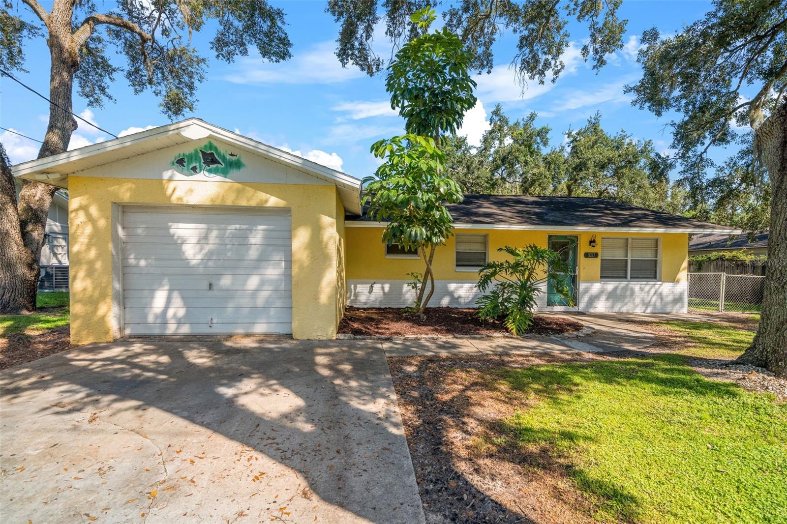 Cozy Charm Meets Convenience in New Port Richey
Step inside this welcoming 2 bedroom block home and you’ll immediately appreciate the open-concept design that makes everyday living feel spacious and connected. With tile flooring in the main areas and warm wood laminate in the bedrooms, the home blends easy maintenance with cozy comfort.
From the moment you arrive, the front yard shaded by mature oak trees creates instant curb appeal and a warm, inviting first impression. Out back, the screened-in porch overlooks a large, fully fenced yard—perfect for pets, play, or outdoor entertaining. Dual side gates, a 1-car garage, and a large storage shed provide all the functionality you need.
Best of all, this home comes with no HOA or CDD fees, giving you the freedom to truly enjoy your property without extra restrictions or costs.
You’ll love the location—just minutes from the vibrant and growing downtown New Port Richey, where you’ll find dining, shops, and community events. Quick access to the Veterans Expressway makes commuting a breeze while keeping you close to everything Tampa Bay has to offer.
This home is a wonderful blend of charm, practicality, and lifestyle—ready for you to make it your own.