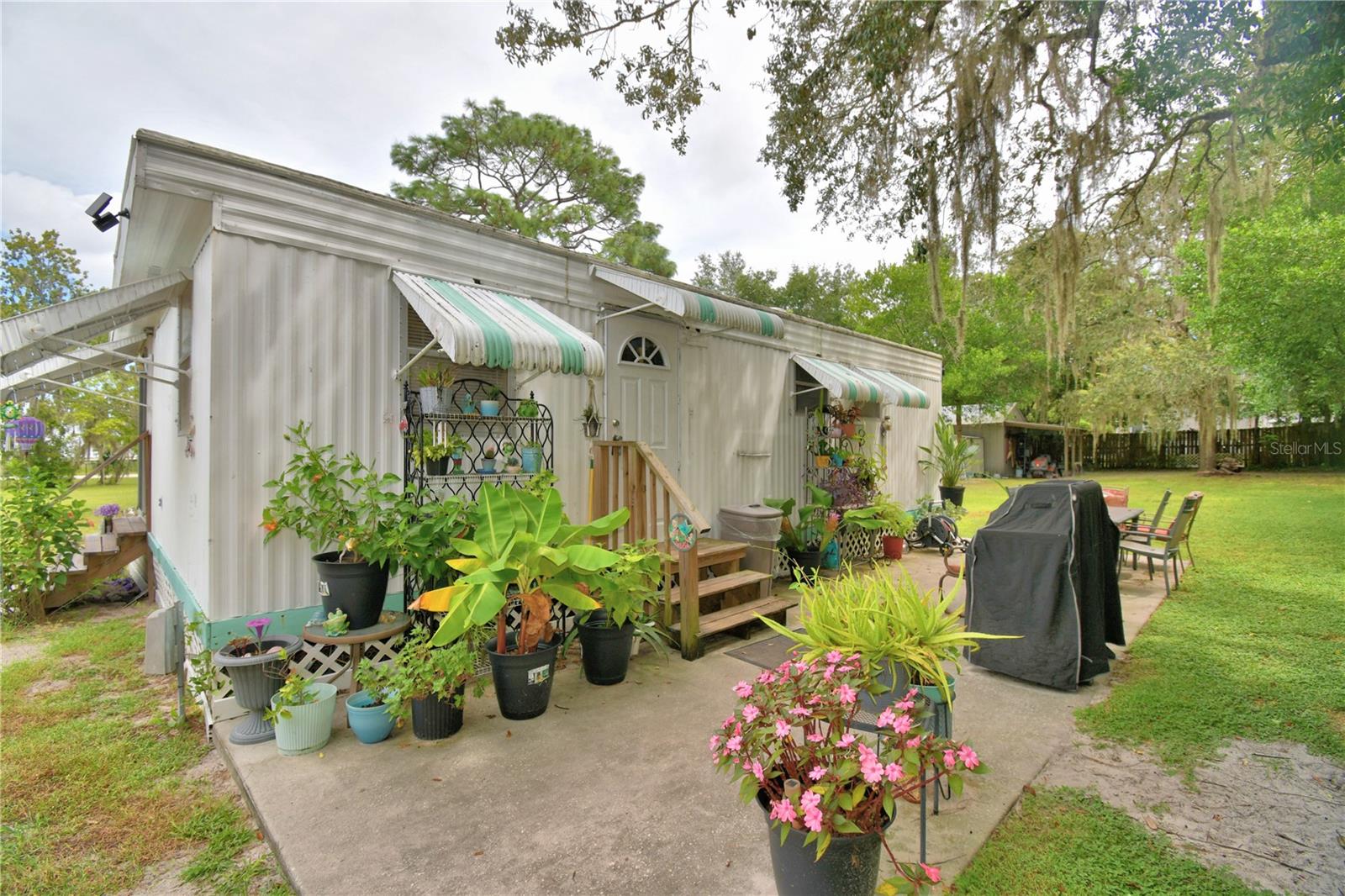 Are you looking for lots of space and no HOA? Then this home could be right for you. This 2/1 home features newer flooring in some rooms, newer appliances in a kitchen with a nook, new submersible well, a workshop with electricity, shed, camper that comes with the purchase and more! This home sits on a very well-kept lot that is almost an acre at .78 with mature landscaping. Don't miss out on this opportunity all for less than 200k.