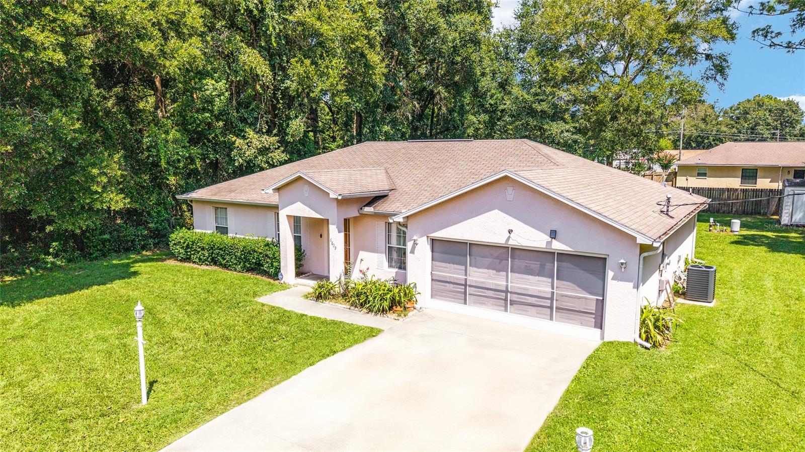 Welcome to this charming 3-bedroom, 2-bathroom home that sits on .46 of an acre in Ocala Park Estates, offering privacy with no immediate neighbors on either side. Built in 2002, the home features 1,169 sq. ft. of living space with a split-bedroom layout, a designated dining area, and a breakfast nook off the kitchen—perfect for casual meals. The master suite boasts two walk-in closets, while the laundry room is conveniently located inside the home. Enjoy Florida living on the screened rear porch, and take advantage of the new HVAC, gutters, and a storage shed out in the backyard. A 2-car garage provides ample parking and storage. With no HOA, plenty of land space, and immediate access to HWY 27, shopping, restaurants, and I75, this home offers both comfort and convenience in a peaceful, private setting.