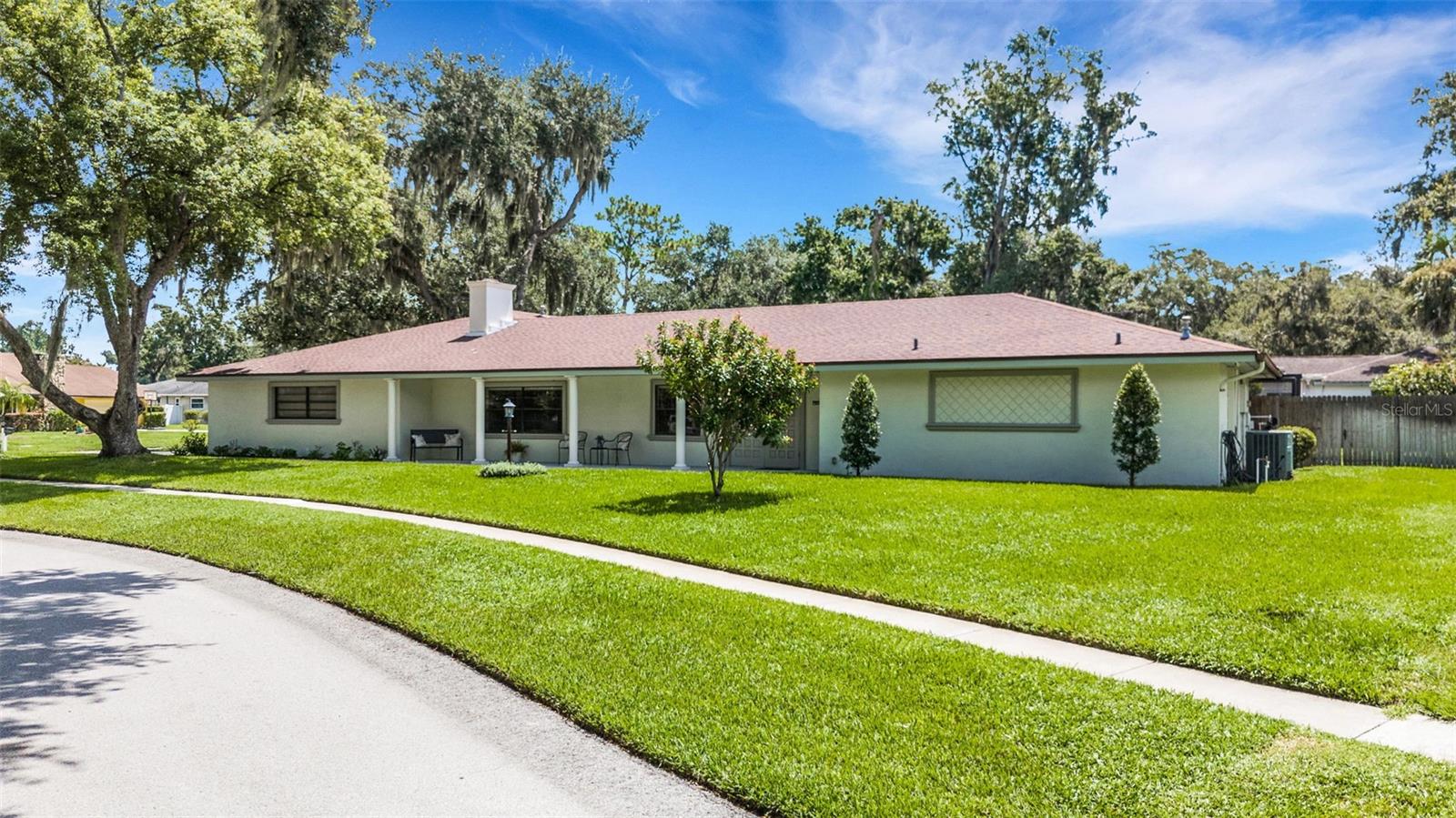 Welcome to Christina Woods, one of South Lakeland’s most sought-after neighborhoods, where shady trees, lush landscaping, and an oversized corner lot set the stage for this beautifully updated 4-bedroom, 3-bath pool home. From the moment you step inside, you’ll notice the charm and thoughtful updates throughout, including wood-look ceramic tile in the main living areas and brand-new carpet in the primary suite. The gourmet kitchen is a showstopper with raised-panel wood cabinetry, soft-close features, granite countertops, stainless steel appliances, a gas cooktop with decorative exhaust hood, built-in oven and convection oven, plus a spacious island with seating, extra storage, and a convenient pass-through window to the pool area. Formal living and dining rooms offer traditional appeal, while the gorgeous family room steals the spotlight with its wood-burning fireplace, custom bookcase, and built-in desk—perfect for work or hobbies.
The split-bedroom layout provides privacy for everyone. The glamour primary suite is your private retreat with sliding doors to the pool area, a huge walk-in shower, dual vanities with granite counters, and a separate bath area. Three additional bedrooms are generously sized—one with its own ensuite bath, another with direct porch access, and a shared pool bath with double sinks and granite counters.
Sliding doors from the kitchen, living room, and primary suite lead to the entertainment-sized screened porch with a custom tile floor and sparkling pool surrounded by a paver deck. Additional features include a 2-car side-entry garage, inside laundry with storage and mop sink, 2 hot water heaters, and a wood privacy fence. All of this in a fantastic location close to schools, parks, shopping, dining, and all that Lakeland has to offer. Call today for your private showing!