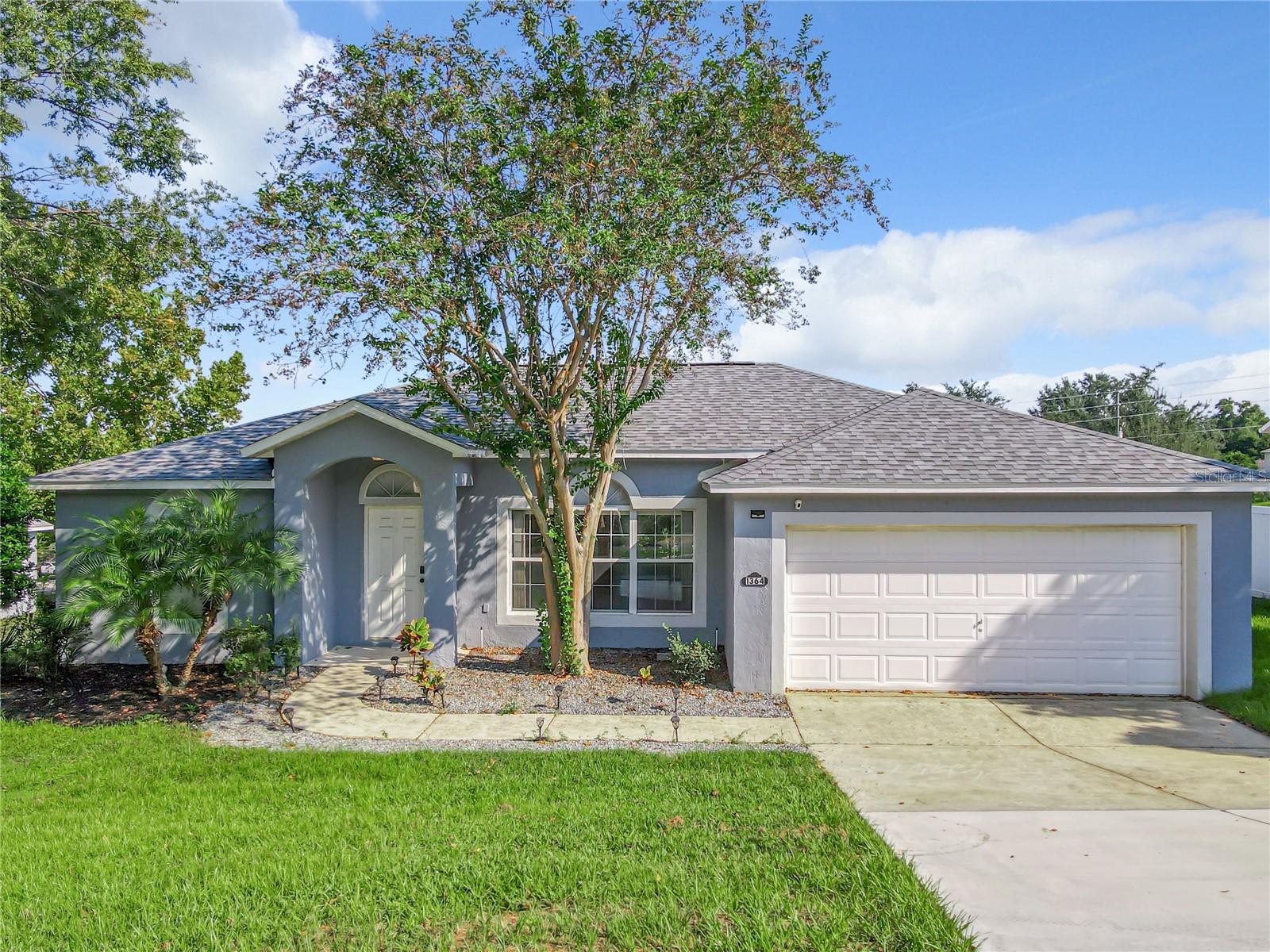 Welcome home to this charming 3-bedroom, 2-bath home in beautiful Clermont! This residence offers many perks you will appreciate such as a 2-car garage, dedicated laundry room with washer and dryer, an abundance of natural light, vaulted ceilings and ceiling fans throughout. The open concept floor plan is perfect for busy households! From the kitchen, keep an eye on food prep, laundry and the spacious backyard with its lush green grass—perfect for outdoor activities, gatherings, or simply relaxing in the sunshine. Off the dining room is a wall of glass sliders leading out to the screened-in-lanai where you can enjoy a cup of coffee or wine - bug free. The primary bedroom features a dramatic tray ceiling, walk-in-closet and en-suite bathroom with dual sinks. The hall bath has a tub/shower combination, perfect for bath time. Additional extras include blinds on all the windows, a community pool and community tennis courts. The zoned schools are less than 10 minutes from the home as well as a plethora of restaurants and shopping. Rental listings do not come up very often in this desirable community so schedule your showing today and see for yourself.