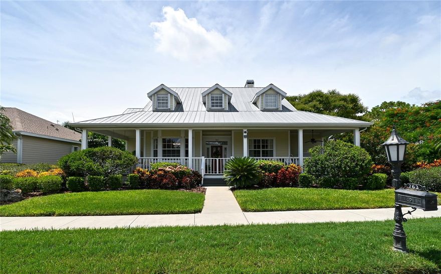 Welcome to this gracious, charming, 2- story home, with an expansive wrap-around front porch, custom built by Gulf Pointe Homes in 1998   This unique model is one of a kind in Rivendell and offers an open, split floor plan with French doors and lots of architectural detailing.  The first floor features a library with built in bookshelves, a formal dining room with bay window, and a large storage closet under the stairway.  The updated galley style kitchen has stainless appliances, 2 built in wine racks and a built-in wine/beverage refrigerator.  Countertops are marble except for the breakfast bar which is granite.  Laundry room off kitchen.  The spacious primary bedroom suite offers an oversized walk-in closet and updated bathroom.  On the opposite side of the home are 2 bedrooms and a bathroom.  Upstairs features a loft, a 4th bedroom, walk-in closet and bathroom with combination tub and shower.  The second floor offers flexible space and can be used according to your needs.  Back downstairs….exit the back of home through lovely set of French doors, onto the lanai and screened pool deck, out the door to a paver brick patio.  Sit down and enjoy the expansive views of lush greenery in a park-like setting.  Cool yourself under colorful Royal Poinciana and Golden Jacaranda trees.  The oversized 2 car garage with attic, is accessed by a private rear alleyway.  The home is outfitted throughout with hurricane protection. An irrigation well on property saves on water bill.   Rivendell is a community of 498 homes on close to 400 acres of lakes and preserves, neighboring Oscar Scherer State Park.  Close to nationally recognized Pine View School, a Sarasota public school for the gifted.  There are tennis courts on the school property that are available to Rivendell residents when school is not in session.  Ideally located within minutes to beaches, golf courses, medical facilities, shopping and much more!