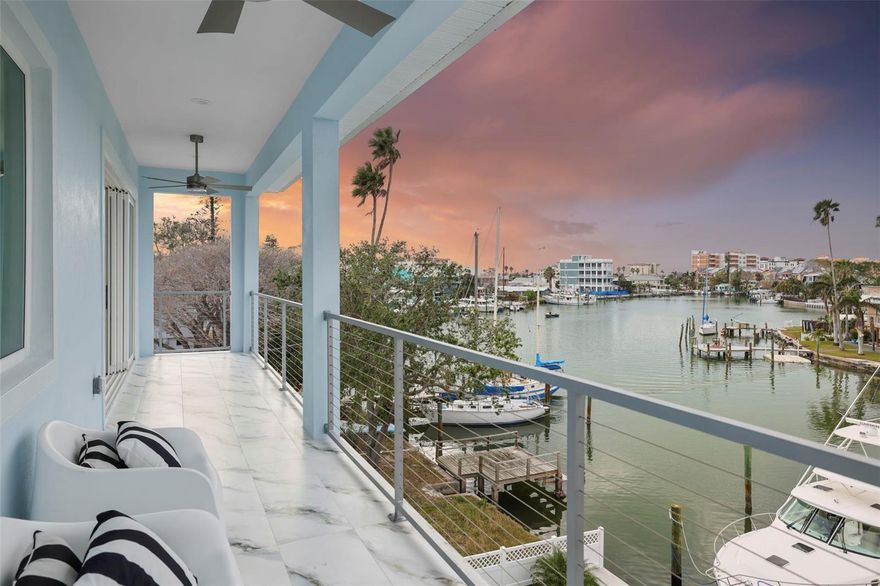 Under contract-accepting backup offers. HUGE Price Reduction. Selling for UNDER appraised value! Iconic Waterfront Living in the Heart of John’s Pass. Experience the pinnacle of coastal luxury in this brand-new, custom-built waterfront estate—an architectural triumph where refined design meets relaxed elegance. Perfectly positioned just steps from the vibrant shops, restaurants, and white sands of John’s Pass Beach, this residence is a rare opportunity to own a true trophy property in one of Florida’s most dynamic waterfront destinations. Elevated over 16 feet above sea level this masterpiece is engineered for peace of mind and long-term resilience. Built on a three-tier foundation with pilings and full concrete block construction on all three levels, it’s fortified with PGT WinGuard impact-rated windows and doors, seamlessly blending safety, sophistication, and efficiency.
Inside, over 3,500 sq ft of beautifully curated living space offers 5 bedrooms (or 4 + executive office) and 4.5 baths, all bathed in natural light and showcasing unobstructed water views from nearly every room. Ride the elevator to the main living floor and enter a grand open-concept layout anchored by a chef’s kitchen worthy of the most discerning culinary enthusiast—featuring Sub-Zero, Wolf, and KitchenAid appliances, quartz surfaces, a warming drawer, convection drawer, and a professional-grade ice maker.
Designer fixtures, 30x60 Apolina White porcelain tile, and custom lighting—including imported pieces from Prague—elevate every detail. The great room opens via expansive glass sliders to a sprawling waterfront terrace—perfect for elegant outdoor entertaining or sunset dining.
Retreat upstairs to the primary suite sanctuary, where a wet bar, private balcony, and spa-caliber bathroom await. Oversized sliders frame picture-perfect views, while a massive walk-in shower, luxurious finishes, and dual vanities complete the experience.
Outside, the ambiance turns pure Key West: a custom Pebble Tech heated saltwater pool and elevated spa are surrounded by white marble decking and lifetime turf. Beyond, a composite dock with deep water access ensures you're always just minutes from open water adventure. The oversized 5+ car garage, including a rear garage door for easy water toy access, offers versatility for a home gym, game room, or car collection. This is more than a home—it’s a lifestyle statement. A showpiece of design, craftsmanship, and location. Schedule your private tour today and experience the finest in modern coastal living.