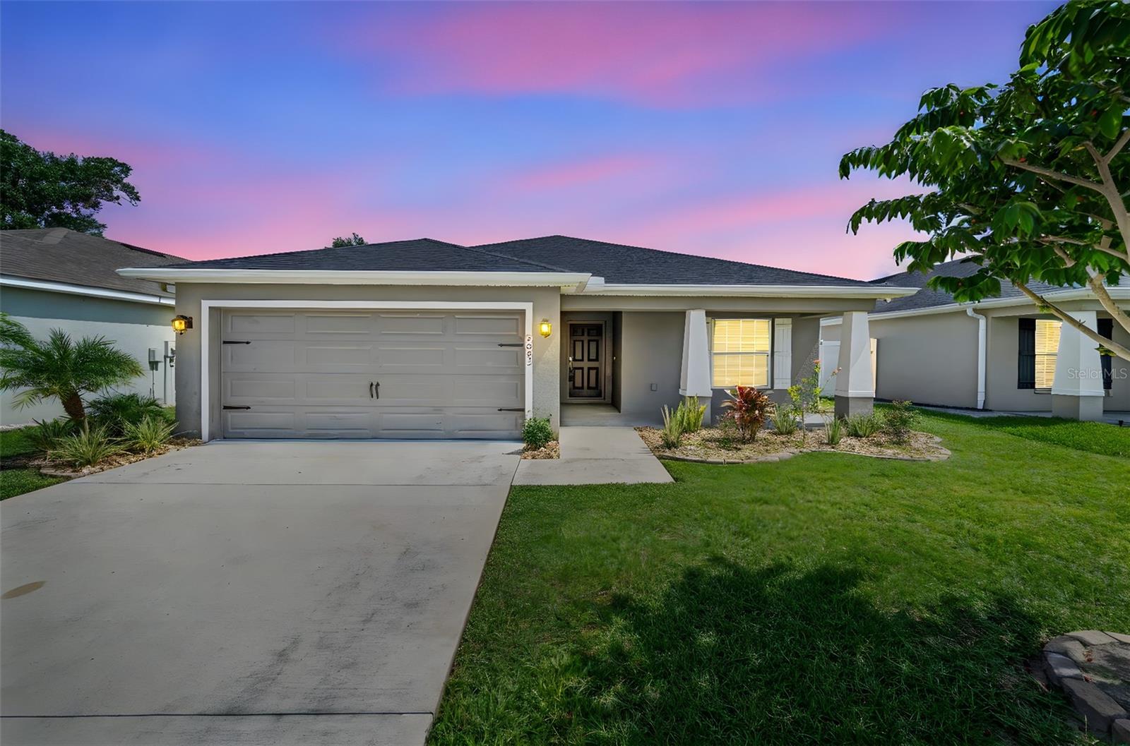 Welcome to this beautifully maintained 4-bedroom, 2-bathroom home built in 2018! Featuring a spacious split floor plan, this home is designed for both comfort and functionality. The open-concept living and dining areas connect seamlessly to a modern kitchen with ample cabinetry and counter space—perfect for everyday living and entertaining. The private primary suite offers a peaceful retreat with a large walk-in closet and a luxurious en-suite bathroom that includes a relaxing soaking tub and a separate glass-enclosed shower. Three additional bedrooms provide versatility for guests, a home office, or a growing family. Step outside to your private backyard oasis with mature fruit trees—ideal for enjoying Florida’s sunshine and harvesting your own seasonal treats. This move-in ready home offers the perfect balance of indoor comfort and outdoor charm. Don’t miss your chance to call it yours!