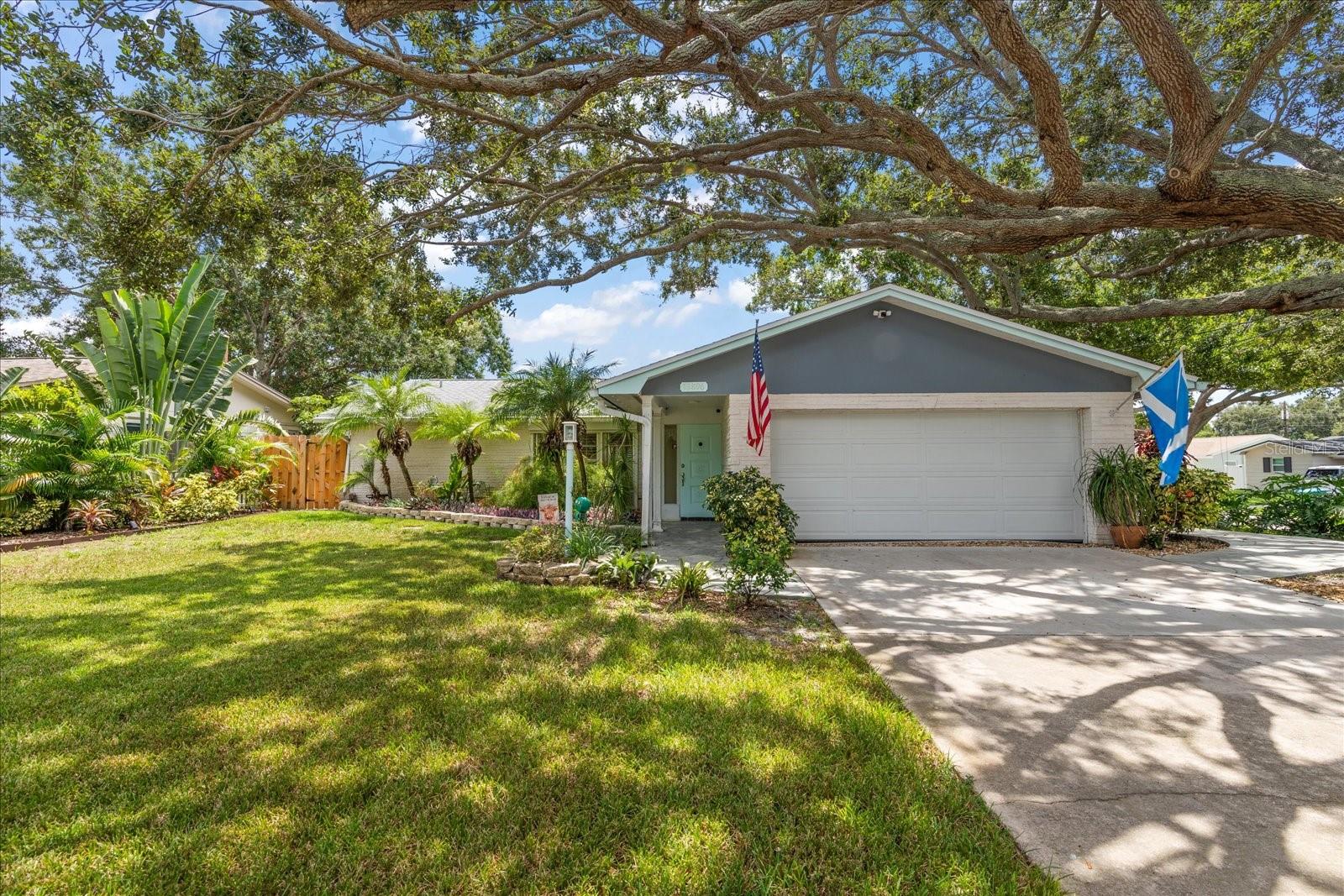 This beautifully maintained 3-bedroom, 2-bath home with a 2-car garage offers comfort, updates, and a fantastic location. The split floor plan provides privacy and function, while the inviting layout makes it perfect for everyday living and entertaining. Key Features & Updates: roof replaced in 2018, electrical and transfer panel installed in 2019, A/C replaced in 2023, both bathrooms remodeled with new shower and bath, and new vinyl flooring throughout in 2025. Not in a flood zone but hurricane shutters are installed on most windows. Enjoy Florida living on the large screened back porch with TV and bar, overlooking a backyard with low-maintenance turf, a new wooden privacy fence, and a shed for extra storage. The garage features a durable epoxy-coated floor and comes equipped with a newer washer, dryer and refrigerator for added convenience. The yard features beautiful oak trees and landscaping, adding to the home’s curb appeal. Located close to the beaches and in a great neighborhood in unincorporated Seminole, this home combines modern updates with a warm, inviting atmosphere.