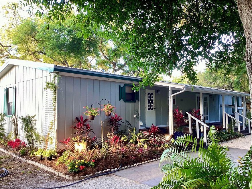 Enjoy Florida homestead living on 4 acres situated on a secluded cul-de-sac 12 miles north of Okeechobee. Numerous features make this property unique and desirable.  These include a large 2000 sq ft barn, with a 550  sq ft air-conditioned workshop, covered 3-car parking bay, and a 20 Kw generator bay. In addition, there is a pole barn, spacious chicken and duck coops and a well-stocked fishpond.  Self-sufficiency is further provided through a 5200 sq ft fenced vegetable garden with a greenhouse and shed.    

The house has been extensively updated and boasts new roof, septic system, porches, A/C system and hot water heater.  The thoughtfully remodeled kitchen features modern cabinets with stainless hardware, extensive tiled back splash, stainless appliances and generous quartz counter tops.  Hardwood flooring runs throughout the open-plan kitchen, lounge and dining areas providing a cohesive feel to the area.  The master bedroom has a luxurious en-suite bathroom and walk-in closet. Two other generous bedrooms share a second, updated bathroom.   Finally, there is a separate den/study.  Enjoy the back porch screened sunroom with its views over open fields to the south, a hot tub and the landscaped, up-lit garden. Large live oaks provide welcome shade in the summer.  
This property is a rare opportunity to own a secluded retreat and provide for self-sufficient living.