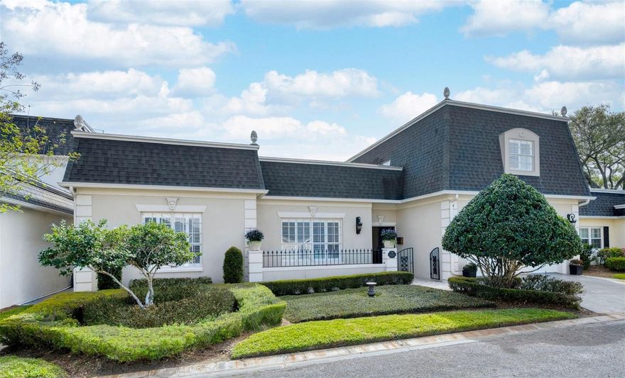 Refined French Provincial Elegance in Country Club Townhouse Estates!
Experience timeless sophistication in this beautifully crafted French Provincial–inspired villa, ideally positioned within the established and impeccably maintained community of Country Club Townhouse Estates. Tucked within the enclave of the stately homes of Spring Lake next to the prestigious Country Club of Orlando and just minutes from the charm of downtown College Park, this exceptional residence offers over 3,100 square feet of thoughtfully designed living space—perfectly suited for both relaxed daily living and effortless entertaining.
A wrought-iron gate welcomes you into the private entry courtyard, where artisan-crafted, intricately detailed iron double doors create a striking first impression. Inside, a gracious foyer illuminated by vintage-inspired lighting sets the tone, opening to an elegant sitting room adorned with rich wood floors, classic wainscoting, crown molding, and a beautiful fireplace that creates a warm and inviting ambiance.
From there, the home unfolds into a truly impressive grand living area, where soaring ceilings and expansive wood floors enhance the sense of scale and openness. A dramatic fireplace serves as the focal point, framed by custom built-ins and architectural niches—perfect for showcasing art and collected pieces. Just beyond, a stylish adjoining bar room elevates the space for entertaining, offering a natural gathering spot for hosting guests. Double French doors line the back wall, opening to a secluded and private patio, creating a seamless indoor-outdoor connection ideal for al fresco dining, morning coffee, or quiet evenings under the stars.
Quietly positioned toward the rear of the home, the dedicated office provides a peaceful and functional workspace, complete with built-in shelving and a window that fills the room with natural light—ideal for working from home or managing daily tasks in comfort.

Rich in detail and functionality, the kitchen features custom cabinetry, granite countertops, and elegant herringbone wood floors that bring warmth and texture to the space. A sunlit window above the sink brightens the room, while stainless appliances, a generous pantry, and a charming eat-in area enhance both everyday ease and livability.
The impressive first-floor primary suite offers a true retreat, with elevated ceilings, refined trim details, a spacious walk-in closet, and a well-appointed bath designed for relaxation and comfort.
Upstairs, two additional bedrooms and a full bath provide comfortable accommodations for family or guests, offering privacy and separation from the main living areas.
An attached two-car garage offers both convenience and ample storage. In the community, residents enjoy access to a sparkling pool set within a beautifully maintained neighborhood known for its mature landscape and welcoming atmosphere.
Ideally located near The Packing District and the popular Great Southern Box Company Food Hall, with the boutiques, cafés, and restaurants of Edgewater Drive just minutes away, this location offers an exceptional blend of tranquility and vibrant city living.
Graceful architecture, generous living spaces, and an outstanding location combine to create a rare opportunity to enjoy refined living in one of Orlando’s most desirable settings.