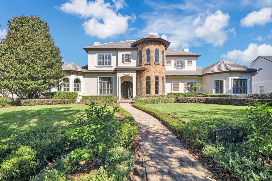 Your stunning Keene’s Pointe custom home by Stonebridge was built for luxurious everyday living and effortless entertaining. The grand first floor features travertine and hardwood floors throughout, a formal living room with gas fireplace and stone mantle, elegant dining room with adjoining dry bar, and a private office with French doors. The secluded primary suite includes a glamorous dressing room, expansive walk-in closet, and an updated spa-like bath with oversized glass shower and dual vanities. Two additional first-floor bedrooms share a full bath, plus a versatile flex room ideal for a secondary office. Thoughtful touches include a well-appointed laundry, mudroom, and a clever under-stair nook. The gourmet kitchen showcases high-end stainless appliances including a Sub-Zero refrigerator and custom cabinetry, opening to a sunny breakfast area and spacious family room with custom-built entertainment center. Large sliding doors reveal the updated lanai with wood-paneled ceiling and travertine decking, seamlessly connecting indoor and outdoor living. A nearby media room with wet bar, wine cellar, and half bath is perfect for movie nights and game days. Upstairs, two ensuite bedrooms are complemented by dual landing spaces featuring a cozy sitting area ideal for work, study, or just relaxation. Outside, enjoy a resort-style backyard with summer kitchen, pool, waterfall, and updated spa with rock accents overlooking a generous private lawn. A 3-car garage is smartly split into two bays for flexible storage and parking. Finishes include custom drapes and shutters, extensive built-ins, detailed moldings, and rich woodwork. Meticulously maintained with recent upgrades: all-newer HVAC units, fresh exterior paint, gas pool heater, irrigation well pump, and more. Move-in ready, beautifully updated, and impeccably cared for this is Keene’s Pointe living at its finest. Be sure to click on the virtual tour links.