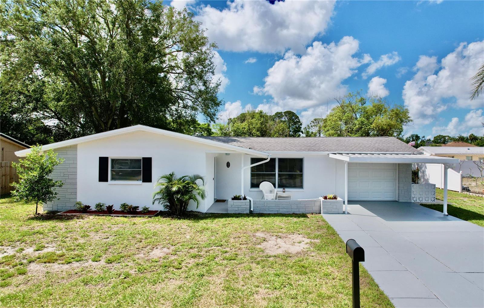 Under contract-accepting backup offers. ****Back on the Market**** Brand New Roof**** Buyer’s financing fell through. Their loss is your gain. Welcome to this charming home that sits on nearly a quarter of an acre. This home provides ample outdoor space for you to enjoy! As you approach the property, you'll notice a garage and sizeable carport, which provides shelter for your vehicle and extra storage space. Step inside and you'll find a spacious 3-bedroom, 2-bathroom home. Enjoy the intimate Florida room, which features vinyl windows that let in plenty of natural light. The generous family room is perfect for relaxing with loved ones. Featuring new paint inside and out, this home feels fresh and modern. The new HVAC system ensures that you stay comfortable year-round, while the new kitchen cabinets, granite countertops, and stainless-steel appliances make meal prep a breeze. The bathrooms have been recently remodeled, and the new laminate and carpet floors throughout the home add a touch of luxury. Don't miss out on this incredible opportunity to own a beautiful home in a highly desirable location!