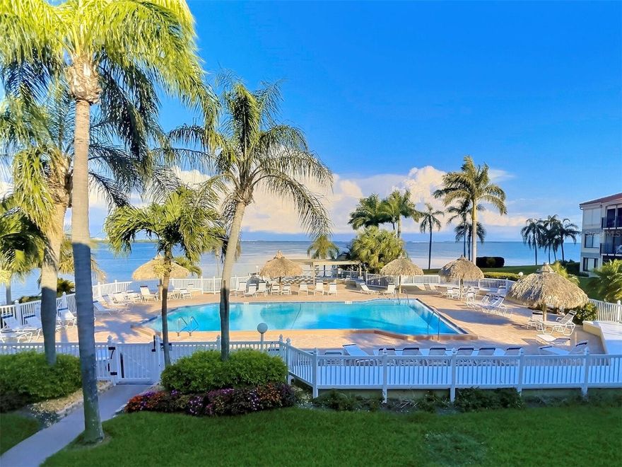 YES! You can have it all… step out on  your private patio to the stunning 180-degree view of the turquoise Gulf, sparkling heated pool and bubbling hot tub. This 2/2 end unit condo, is the on the 2nd floor of a low-rise building in the golf community of Isla Del Sol. Views of the skyway at night are stunning! This condo features a primary suite with walk-in closet and full bath. Features include newly surfaced patio deck with electric storm shutter, new hot water heater, all new window treatments. The storage closet has W/D connections. Enjoy the large community room with TV and pool table. The HOA fee includes ground care, pool, spa, security, water, sewer, trash, internet, and cable tv. You have a dedicated parking spot plus plenty of guest parking. Only a 15 minute drive to downtown St. Petersburg, St. Pete Beach and Ft. De Soto Park. The views are amazing!  A perfect place to live full or part time! Professionally designed furnishings are available and negotiable if desired. Call for a tour today!