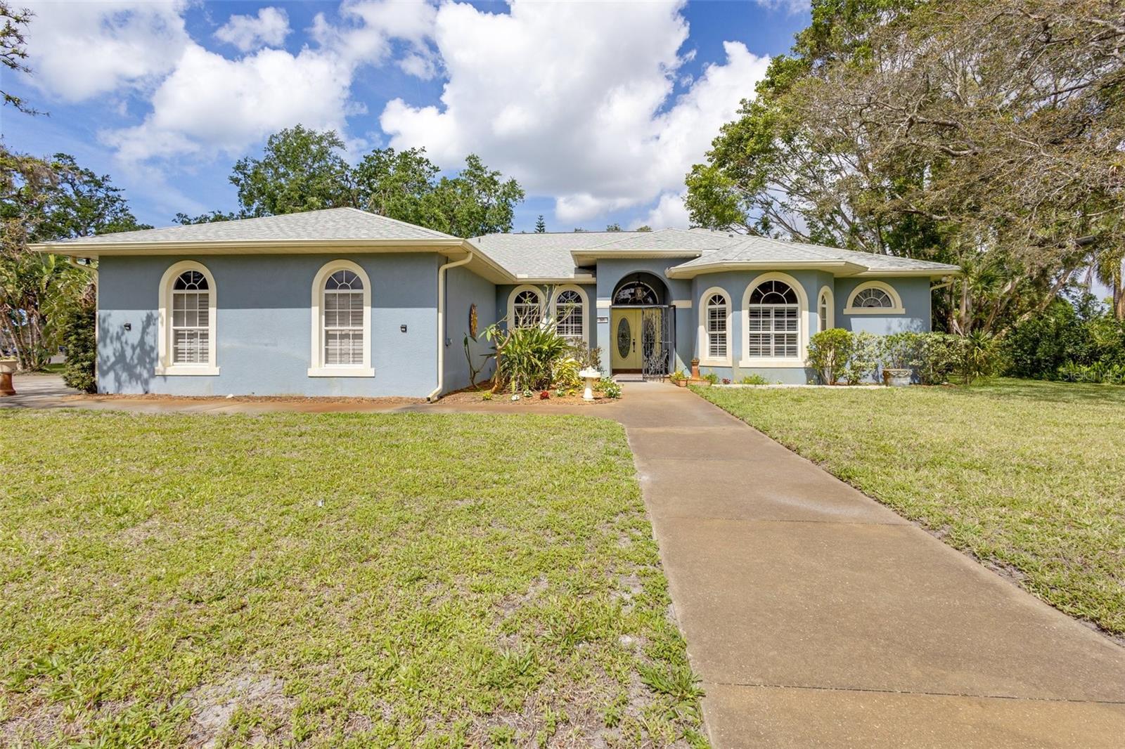 Welcome to this thoughtfully designed custom-built Mark Cahill home located in the desirable Whitfield Estates with over 3000 square feet. As you enter the home through the wrought iron gated porch, you will notice it has been designed to fit a multi-generational family. The center of the home is a large family room with a fireplace and view of the backyard through the corner window. The kitchen features a breakfast bar, granite counter tops, a custom designed range hood and a large breakfast nook. There is a walk-through pantry to store all your fun kitchen gadgets, dishes or the monthly big box grocery haul. The large laundry room features a folding area and cabinets for extra storage, and you have access to the garage, kitchen, pantry and two more-bedroom suites. The formal living room and formal dining room are situated next to the kitchen. The dining room has been upgraded with extra insulation to provide for a quiet dinner while entertaining guests. The formal living room allows for a more relaxing area to enjoy conversations or just some alone time. From this area you have your primary bedroom and bathroom, the office/den and a powder room.
This home is situated on one of the largest lots in the area with .51 acres of land. This allows you to have space between you and your neighbors. There is no HOA or CDD fees in this community. However, if you would like you can join the Sara Bay Country club and enjoy a round of golf or one of their fabulous items on the menu. Sarasota Bay is close by so you can enjoy the sunsets, fish or just sit and relax. With The Ringling Museum, Downtown Sarasota, Anna Maria Island, UTC shopping and dining, the best beaches like Siesta, Lido and Long boat key close by, there is plenty of things to do an enjoy. Additional features: 2 A/C units, re-roofed in 2021, 10’ ceilings, durable Saltillo tile, pool table stays, echo thermostat, deep well to water lawn, outside shower, commercial grade gutters with Leaf Gard installed. This home and location in Sarastoa offer so much and the seller is offering $5000.00 towards the buyers closing cost with an accepted offer.