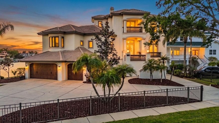 Nearly 300 feet of rare waterfront along Whitcomb Bayou and Spring Bayou highlights this exceptional Arthur Rutenberg custom estate with 4 bedrooms and 4.5 bathrooms. Designed to capture the beauty of its surroundings, the home showcases panoramic water views from nearly every room, creating a seamless connection between elegant interior spaces and the spectacular natural setting. The open floor plan is ideal for both everyday living and entertaining, featuring a formal dining area, oversized family room, and a chef’s dream kitchen outfitted with upgraded appliances and generous workspace. A charming breakfast nook is perfectly positioned to overlook the bayou, while a light-filled office offers a peaceful workspace surrounded by water views. Two guest bedrooms share a bathroom, while the split floor plan provides privacy for the primary suite, complete with a soaking tub, dual vanities, walk-in shower, private water closet, and spacious walk-in closet. French doors open to a sprawling waterfront deck overlooking the pool and expansive bayou views. Brand New Elevator services all 3 floors!  The third-floor additional primary retreat offers a luxurious private escape with an oversized sitting area, access to two private balconies, a wet bar, and an elegant ensuite bath featuring dual vanities, soaking tub, walk-in shower, separate water closet, and dual walk-in closets. The ground level offers four-plus garage bays, providing incredible room for recreation equipment, vehicles, golf carts, and water toys, along with 1,800+ square feet of additional uninsurable space. French doors provide convenient access to the pool area from both the main living level and the ground floor. Completing the waterfront setting is a boathouse and an additional dock with lift, ready to be redesigned by the new owner to fully maximize this exceptional boating property. From the moment you step outside, the home’s connection to the surrounding waterfront lifestyle becomes clear. Residents enjoy close proximity to Craig Park, featuring tennis courts, walking trails, a community center, boat ramp, and kayak launch, as well as the Tarpon Springs Yacht Club and nearby Fred Howard Park. Golf cart access leads to the historic Tarpon Springs Sponge Docks and vibrant downtown Tarpon Springs filled with restaurants, boutiques, festivals, and year-round celebrations. For boating enthusiasts, the adventure continues just beyond your dock. A short cruise down the Anclote River leads directly to the Gulf and some of the region’s most award-winning barrier island beaches, including the untouched shores of Anclote Key Preserve State Park and nearby Caladesi Island State Park, offering pristine sand, turquoise waters, and miles of undeveloped coastline rarely found along Florida’s Gulf Coast. The surrounding bayous are known for their natural beauty and vibrant marine life, where dolphins and manatees are frequent visitors and boating, fishing, and kayaking are part of everyday life. Each holiday season, the waterways come alive with the celebrated Tarpon Springs Christmas Boat Parade and the annual Epiphany Celebration—traditions that perfectly reflect the charm and heritage of this iconic coastal community. This remarkable residence offers a rare combination of architectural quality, expansive waterfront, and an unmatched Tarpon Springs lifestyle.