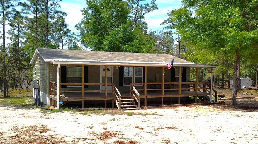 Discover this charming waterfront retreat on 2.97 acres—perfect as a full-time sanctuary or a relaxing vacation getaway. Situated on a desirable corner lot, this partially wooded property offers added privacy, with mature live oaks and pines creating a serene natural setting around the home.  Enjoy outdoor living with an amazing 40' x 10' covered front porch and a screened patio that measures 15' x 10' out back that's ideal for relaxing or entertaining. Nestled on peaceful Slipper Lake, you’ll love ending each day with breathtaking sunset views.  Inside, the home features a wonderful open floor plan and a spacious owner’s suite with a private bathroom. If you've been dreaming of buying, but a bit short on cash to close, the seller is willing to assist with buyer closing costs!