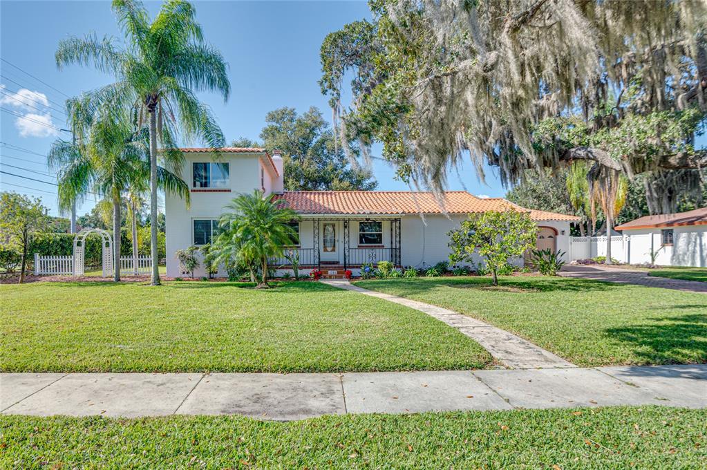 ONE-OF-A-KIND MOUNT DORA PROPERTY WITH SEPARATE QUARTERS FOR IN-LAWS OR RENTAL INCOME!!! Come see this move-in ready, architectural gem just minutes from the Mount Dora Historic District, Lake Gertrude, and Lake Dora! Drive up to the property and notice Mediterranean style detail with tiled and wrought iron railing porch, brick trim accenting doorways and windows, stunning palm and fruit trees, and grand ESTATE feel. "Attention to quality" is a phrase that should come to mind when walking this property, which features original HARDWOOD FLOORS, crown moulding, 5.5" baseboards, and NEW WALL PAINT throughout the home! ALL OUTSIDE PRESSURE WASHED AND PAINTED in 2022! Enjoy special times with friends and family in the living room with wood-burning fireplace and in the family room with view to the screened courtyard through fully retractable glass sliders - both rooms featuring 8.5' ceilings. The primary suite (only carpeted area of the home) has a partial LAKE VIEW, two custom closets, and en suite bathroom with large double-sink vanity, a double shower, heated floors, separated toilet, and additional custom walk-in closet! In fact, ALL bedrooms feature en suite bathrooms!
Downstairs also features a guest suite, updated kitchen with stainless steel refrigerator, microwave and KENMORE ELITE RANGE, as well as granite counters and counter extension providing extra work space. Updated cabinetry even features two counter appliance cubbies to maximize counterspace. Adjacent is a stepdown laundry room with additional cabinetry and access to the arched carport separating the main house from additional guest quarters. The main house upstairs guest suite is ideal for a HOME OFFICE, with electrical outlets added along baseboards.
The separate GUEST QUARTERS is a spacious studio apartment with kitchen and full bath (both 2015) and features its own off-street parking with a circular driveway in front. A great INCOME OPPORTUNITY for a buyer wanting a rental unit on-site for EASIER MANAGEMENT but with clearly-defined physical separation between landlord and tenant.
Nestled between the main house, guest house, and detached two-car garage is a 900 sq ft SCREENED COURTYARD featuring a raised patio area, landscape corner, and numerous outlets to power fountains or entertainment lighting! The backyard features more fruit trees, a shed, and a GATED DOUBLE CARPORT.
Updates to the property include: 2022 main and guest house WINDOWS REPLACED; 2021 TRANE HVAC with WiFi touch thermostat (serviced 2022); 2020 WATER HEATER, washer/dryer, replumbing; 2013 WHOLE HOUSE WATER TREATMENT and kitchen REVERSE OSMOSIS system (filters replaced 2022); 2009 TILE REROOF and 2014 flat reroof; 2015 guest house kitchen, wiring, and plumbing; 2017 vinyl fence; 2009 paver driveway; 2003 electrical panel; 2002 detached garage.
Mount Dora is a "golf cart community" known for historic buildings, large canopy oak trees, abundant lakes, unique shopping and dining, numerous annual festivals, and the Mount Dora Village Market nearly every Sunday. Nearby, old railroad tracks are part of a proposed Rails-to-Trails conversion into the multiuse recreation Tav-Dora trail (phase 2). This property's proximity to all that Mount Dora offers as well as modern grocery and home improvement conveniences makes for an outstanding location. Be sure to include this property in your home search plans - but hurry, before this opportunity is gone!! Room Feature: Linen Closet In Bath (Primary Bathroom).
