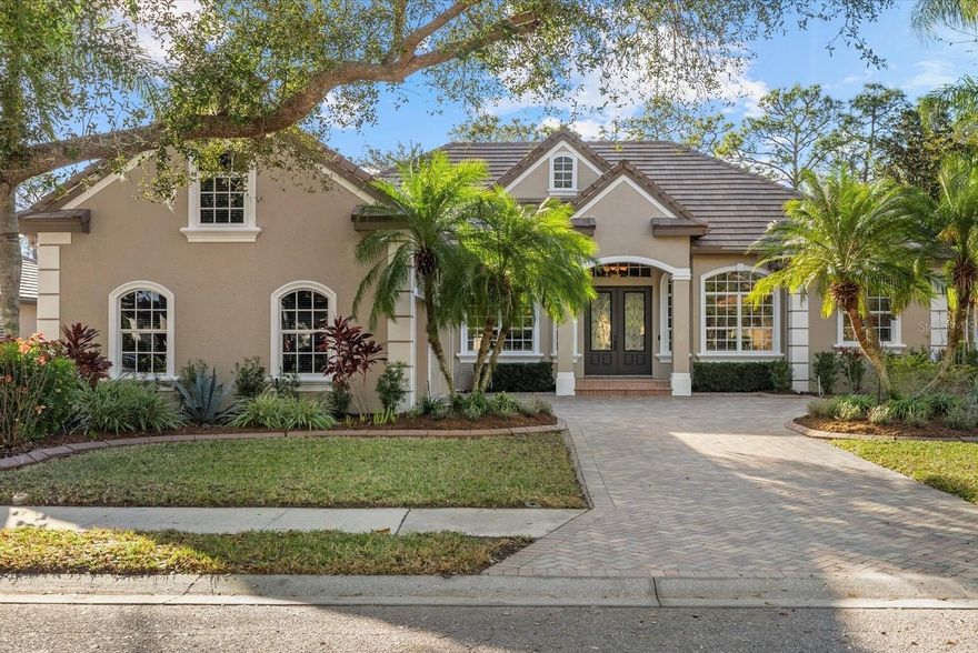 Located in the coveted Sanctuary section of River Club, this meticulously maintained Todd Johnston home offers exceptional quality, thoughtful upgrades, and true Florida indoor-outdoor living, all in a central location with very low HOA fees and NO CDD fee. Plus, it has a brand NEW TILE ROOF! The Sanctuary is known for its winding streets lined with charming gas street lamps, mature trees, abundant wildlife and friendly neighbors, creating a peaceful and private setting. Offering 3/4 bedrooms, 3 full baths, a dedicated office, custom wine and whiskey bar, and a spacious upstairs bonus room that can easily serve as a 4th bedroom, home theater, or playroom, this residence features 3,298 square feet of beautifully designed living space filled with architectural character. From coffered ceilings and crown molding to stone feature walls, custom built-ins, plantation shutters, and detailed trim work, the home showcases craftsmanship throughout. Curb appeal is enhanced by a paver driveway, double glass entry doors, and upgraded landscaping with decorative concrete curbing. Pride of ownership is evident at every turn. Inside, the open layout is highlighted by a living room with coffered ceiling, crown molding, and a contemporary stone accent wall with lighted display shelves. The office features custom built-in cabinetry, desk space, and shelving. At the heart of the home is the kitchen which includes an eat-in area with aquarium glass overlooking the pool and preserve, along with a built-in desk area for everyday organization. The family room showcases a custom stone feature wall with a fireplace and is wired with in-ceiling speakers that extend to the dining room, office, and lanai. Designed for entertaining, the wine and whiskey lounge is a standout feature, complete with modern barn doors, stone countertops, custom cabinetry, shelving, wall and ceiling details, and two Allavino wine coolers with 177-bottle capacity each. Pocketing sliders in both the living and family rooms fully open to the lanai, seamlessly blending indoor and outdoor living. The heated saltwater pool and spa are surrounded by pavers and framed by two covered areas ideal for dining and lounging. Western exposure provides breathtaking sunset views, while the private preserve backdrop ensures tranquility. The primary suite enjoys serene preserve views, a sitting area, walk-in closets, and a renovated en-suite bath featuring a soaking tub, dual vanities with lighted mirrors, and a spacious walk-in shower. Two guest bedrooms and two updated bathrooms are located on the main floor. Upstairs, the expansive bonus room offers exceptional flexibility. Recent updates and improvements reflect meticulous care: the pool has been resurfaced including the waterline tile, the pool cage re-screened with stainless steel fasteners, the interior repainted in 2023/2024, exterior repainted in 2022, new front landscaping installed in 2023, and new carpet added to the primary bedroom in 2025. Additional highlights include a laundry room with utility sink, cabinetry, generous counter space, and second refrigerator, a storage room already plumbed for a future powder bath if desired, and a three-car garage with a workbench, cabinets, and storage space under stairs. River Club is centrally located to all that Lakewood Ranch has to offer with a low HOA fee and it is one of the few communities in Lakewood Ranch without a CDD fee!