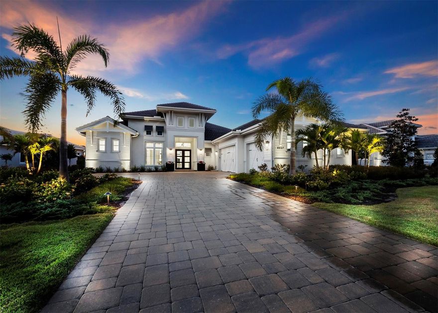 Live your best life in Lakewood Ranch's most exclusive village, the Lake Club. A fully gated community, rich with amenities and beauty like no other. 8507 Pavia Way was built in 2022, better than new, this Gardenia III floor plan features 5 bedrooms(including guest casita), den/study, 3 car garage, and room for everyone, with 4185 sq ft under air all on one level! This great room-style estate home highlights the exceptional water views with western exposure and sunsets for days. The main rooms and bedrooms open to the rear of the home and lanai, looking through the outdoor living spaces and past the pool to the water is an ever-changing masterpiece with colorful skies and wildlife to enjoy! The magnificent outdoor living space features travertine pavers, clear-view screen for enjoying lake/sunset views, swimming pool and spa with led lighting, 4 waterfall pots, huge sun shelf and pool, a summer kitchen with built in grill, sink, beverage fridge, stone counters, seating area with large fan and gas fireplace, and generous dining al fresco covered space. The contemporary style home is a neutral palette with thoughtful clean lined architectural details. The timeless, white kitchen is adorned with all Jenn-Air appliances, including a 5-burner gas cooktop with grand hood, in wall oven, microwave/convection, and warming drawer, extra-large island with dazzling quartz counters and glass backsplash, and a walk-in pantry. Throughout the home, rooms have gleaming wood look floors, opulent chandeliers and led lighting. The primary suite is an owner's retreat with large sitting area and French doors overlooking the pool and expansive lake. It features two walk-in closets and bright and spacious bath including a tub, extra-large shower with room for two, separate vanities and water closet. Located off the main living area is a separate family/game room(4th bedroom) with ensuite pool bath and large walk-in closet. The 5th bedroom is a private casita with kitchenette and full bath, it also enjoys expansive pool and lake views. Bedrooms 2 and 3 are split from the others offering abundant privacy and convenience, each with ensuite baths and generous closet space.  The large laundry room with cabinets and utility sink is fit for a queen!  Electric shades and plantation shutters on windows and doors are throughout the home. The Lake Club is home to a 20,000 sq ft Grande Clubhouse, a private fitness center with state-of-art cardio and strength training equipment, a beautiful resort-style pool with dramatic waterfall features and a separate children's pool, tennis courts, pickleball courts, children’s playground, dog park, yoga lawn and basketball court. A full-time activities director is available to create and oversee the array of culinary, wellness, enrichment, and signature events that is the hallmark of lifestyle in The Lake Club. Just a short drive to beautiful downtown Lakewood Ranch, Waterside, UTC Mall, many golf course options, downtown Sarasota, I-75, and the pristine Gulf Beaches. Come enjoy the Lake Club resort lifestyle!