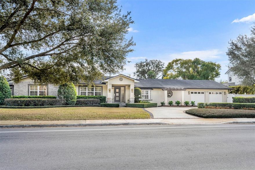 This 1-story home on a corner lot offers easy living in one of Winter Park’s most convenient locations! Enter through a covered front porch and inviting foyer with slate tile floors to discover a desirable split-bedroom floorplan. Off to the right, the spacious primary wing (later addition) serves as a true retreat, with vaulted ceilings, hand-carved wood floors, a cozy window seat wrapped in a bay window, and French doors that lead to the private outdoor living spaces. The large primary bath has dual vanities, a soaking tub, huge walk-in shower, and a custom walk-in closet....This primary retreat is a HUGE surprise! On the opposite side of the front entrance, the home’s original, refinished hardwood floors stretch throughout the living room, kitchen, and large secondary bedrooms. The kitchen features stainless steel appliances, a wine refrigerator, and a dinette area with a precious greenhouse window, perfect for growing fresh herbs and potted plants. The kitchen/dinette area open up to the window-lined living room, with plantation shutters. French doors off the adjacent dining room lead to a newly PVC-fenced rear courtyard with brick pavers and a soothing fountain. The left side of the property includes a screened patio with terracotta tile and a vaulted, wood-plank ceiling, while the right side offers a fully-fenced space for pets, gardening, or play. Enjoy an impeccably landscaped yard with Zoysia grass and a private well for irrigation, plus an enormous 2-car garage that was thoughtfully added on, with a large, sunny laundry area with a double utility sink, and plenty of room for storage or a workbench area. Block construction and updated double-pane windows & doors make the home remarkably quiet inside, and the circular front drive and expanded driveway makes life on Palmer a breeze! Just across the street, Phelps Park provides a playground, tennis, pickleball courts, and additional parking for your larger gatherings. Located just a block from the YMCA, minutes from Publix, Sprouts, Walgreens, and numerous restaurants, and less than 2 miles from Park Avenue, this home is where convenience meets comfort.
