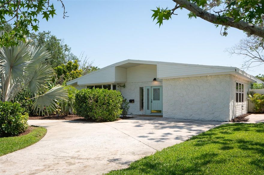 Some homes just get it right—and this one does just that. A 1953 mid-century beauty with vaulted, beam-lined ceilings that was clearly designed for Florida living, not just looks. Two distinct living areas give you space to gather or spread out, anchored by a functional fireplace that you can cozy up next to. The kitchen sits at the center with Taj Mahal quartzite countertops, stainless steel appliances and additional cabinetry in the dining area complete with a wine fridge. Thoughtfully arranged for both privacy and flexibility, the home offers a true primary suite complete with custom closets, one walk in and the other built in, and its own bath with double sinks, plus a separate guest suite with a private bathroom and entrance—perfect for visitors. Two additional bedrooms round out the space. Step outside and it only gets better. A large lanai opens to the pool and freshly updated landscaping, creating a backyard that feels like a natural extension of the home—easy, relaxed, and ready to be used. Meanwhile up front you have the view of the golf course of St Pete Country Club and Boyd Hill Nature Preserve, as well as your own golf cart charging pad. Just a short drive to downtown St. Pete, Gulfport, and the beach—you’re right in the middle of everything while still feeling tucked away. Roof, electrical panel, ac ductwork, and heater replaced in 2025. This is one of those rare homes where the design, layout, and lifestyle all come together effortlessly.