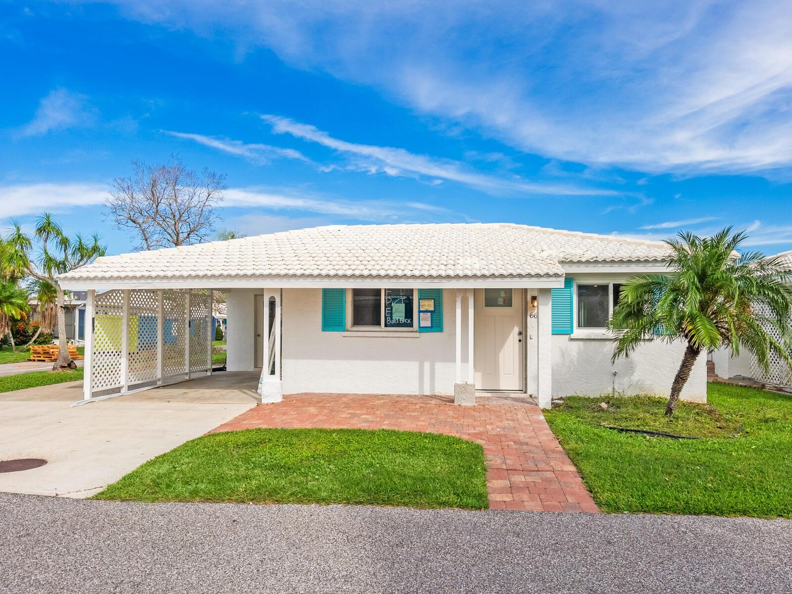 Spanish Main Yacht Club on Longboat Key is a warm and vital boating community with its own private beach access to the Gulf beaches, pool, clubhouse and boat slips. The community is undergoing a renaissance of sorts as many units (including this one) did have water intrusion in the summer storms of 2024. This owner has contracted with the community contractor and has paid related assessment and work is underway! This unit has a bright open floor plan and hurricane windows. Main living area has tile flooring and both bedrooms will have new carpet. There are two bonus area's, one is adjacent to the primary bedroom and could be a private reading area or office and the other adjoins the great room. Once completed this unit will have two new baths, new appliances, kitchen updated, four replaced hurricane windows, new doors and new paint throughout. This villa is on the corner and has a much-coveted additional parking pad giving as many as four parking spaces depending on car size. The laundry room, typical of Florida is in a separate room under the car port. Longboat Key is truly paradise. A barrier island off Sarasota Florida, where you can find wonderful restaurants, community tennis facilities, parks, bike lanes and a short drive away is Sarasota and Anna Maria Island.