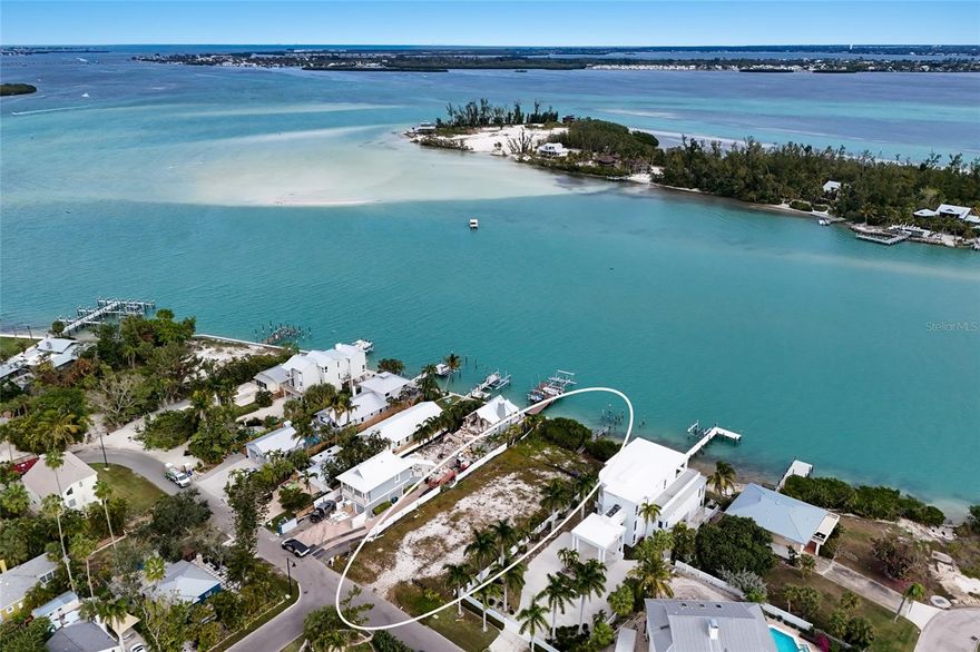 A rare opportunity to craft a bespoke waterfront estate on the coveted north end of Longboat Key. Situated on over 11,000 square feet, this exceptional vacant homesite offers sweeping water views overlooking picturesque Jewfish Island, creating a serene and ever-changing coastal backdrop for your future residence. Cleared and ready for your builder, the property invites endless architectural possibilities—from a contemporary coastal retreat to a timeless island classic—designed to capture breathtaking sunsets, early morning sunrises and gentle bay breezes.Tucked away on a quiet street, this prime location offers the perfect balance of privacy and convenience. Enjoy a short stroll to the pristine Gulf beaches, where powdery white sands and turquoise waters define the Longboat Key lifestyle. Equally close are the coastal restaurants of the north end, allowing you to savor waterfront dining, casual cafés, and evening strolls without ever getting in the car.
Whether you envision expansive indoor-outdoor living, a resort-style pool and lanai, or a private dock to explore Sarasota Bay and beyond, this homesite provides the canvas to bring your vision to life. Surrounded by natural beauty and neighboring luxury residences, 7049 Longboat Drive N represents an increasingly rare chance to build new on Longboat Key—one of Florida’s most desirable barrier islands.
Create your legacy property in a setting defined by tranquility, walkability, and stunning waterfront vistas, all just moments from the Gulf of Mexico. Opportunities like this on Longboat Key’s north end are limited—secure your place and begin designing the extraordinary.