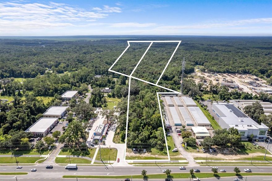 Exceptional Commercial Development Opportunity in Gainesville, FL – Priced to Sell! LAST OF ITS KIND! This rare 16.26-acre commercial site is available in booming Gainesville, FL, priced at just $1.95M for a quick closing, well below its appraised value of $2.7M. An unparalleled opportunity for savvy investors and developers! Key Features: • Prime Location: The property includes three parcels with 160’ of direct frontage on Southwest Archer Road, a major 4-lane state road, ensuring maximum visibility and accessibility. • High Traffic Counts: With an average daily traffic count of 27,500-37,500, this site guarantees significant exposure, ideal for retail, services, and industrial operations. 
• Flexible Zoning: Currently zoned MP (Industrial Services and Manufacturing), this land allows for a wide range of permitted uses, including: • Warehousing, Storage, and Distribution: Ideal for logistics. • Business Services: Perfect for offices and professional services. 
• Educational Facilities: Opportunities for vocational schools or training centers. • Vehicle Sales and Servicing: A prime location for dealerships. 
• Heavy Machinery Sales: Cater to the construction industry. • Radio or Television Station (excluding tower): A unique opportunity for media. • Research, Development, or Experimental Lab: Great for innovative businesses. • Medical Clinic or Lab: Catering to community healthcare needs. • University or College: Potential for higher education expansion. • Vocational or Trade School: Align with local educational focus. Strategic Advantages: • Proximity to Major Retailers: The site is conveniently located near national retailers and hotels, enhancing commercial viability. • Access to Educational Institutions: Just 4 miles from The University of Florida, ensuring a steady influx of students and faculty. • Transportation Accessibility: Located 13 miles from Gainesville Regional Airport for easy business travel. Community and Lifestyle: Gainesville is a vibrant community rich in culture and recreational opportunities. Known for historic preservation, the city features: • World-Class Museums and Performing Arts: Engage with the local arts scene, enhancing quality of life. • Diverse Culinary Landscape: Enjoy a variety of dining options. • Outdoor Recreation: With 8 state parks and over 100 miles of trails, residents can enjoy biking, hiking, and birdwatching. Investment Potential: Investing in this property offers not only a prime location but also the potential for significant returns in a growing market. Gainesville’s economy is supported by education, healthcare, and a diverse population, ensuring robust demand for commercial services. Call to Action: This prime commercial development site at an exceptional price won’t last long. Act now to secure your future in Gainesville’s thriving market! Contact us today for more information and to schedule a viewing. Don’t miss out on this incredible investment opportunity!