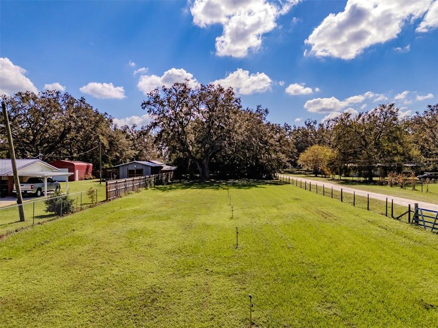 This 2.27 acres is zoned for Agricultural - Single Family AS-1 and offers great potential and unlimited possibilities for any buyer. You can build your dream home here and have room for your horses or cattle of choice. This acreage also has potential for a tree farm as the front of the property has sprinklers on it. There is a pole barn on the property that has electric, plumbing & septic and offers a spacious screened enclosed porch. The pole barn offers a kitchen, bathroom and a loft with a cypress ceiling and cypress walls. There is a 14x30 carport off of the barn and 1,100 sq ft brick pavered patio. There is a shed near the pole barn that has electric and AC. This tree shaded property is fenced and has a gate at the entry. There is a mobile home and a shed on the property that are tear downs. Located in a quiet area and minutes to I-4 and HWY 92 making it a quick and easy commute to Lakeland and Tampa.