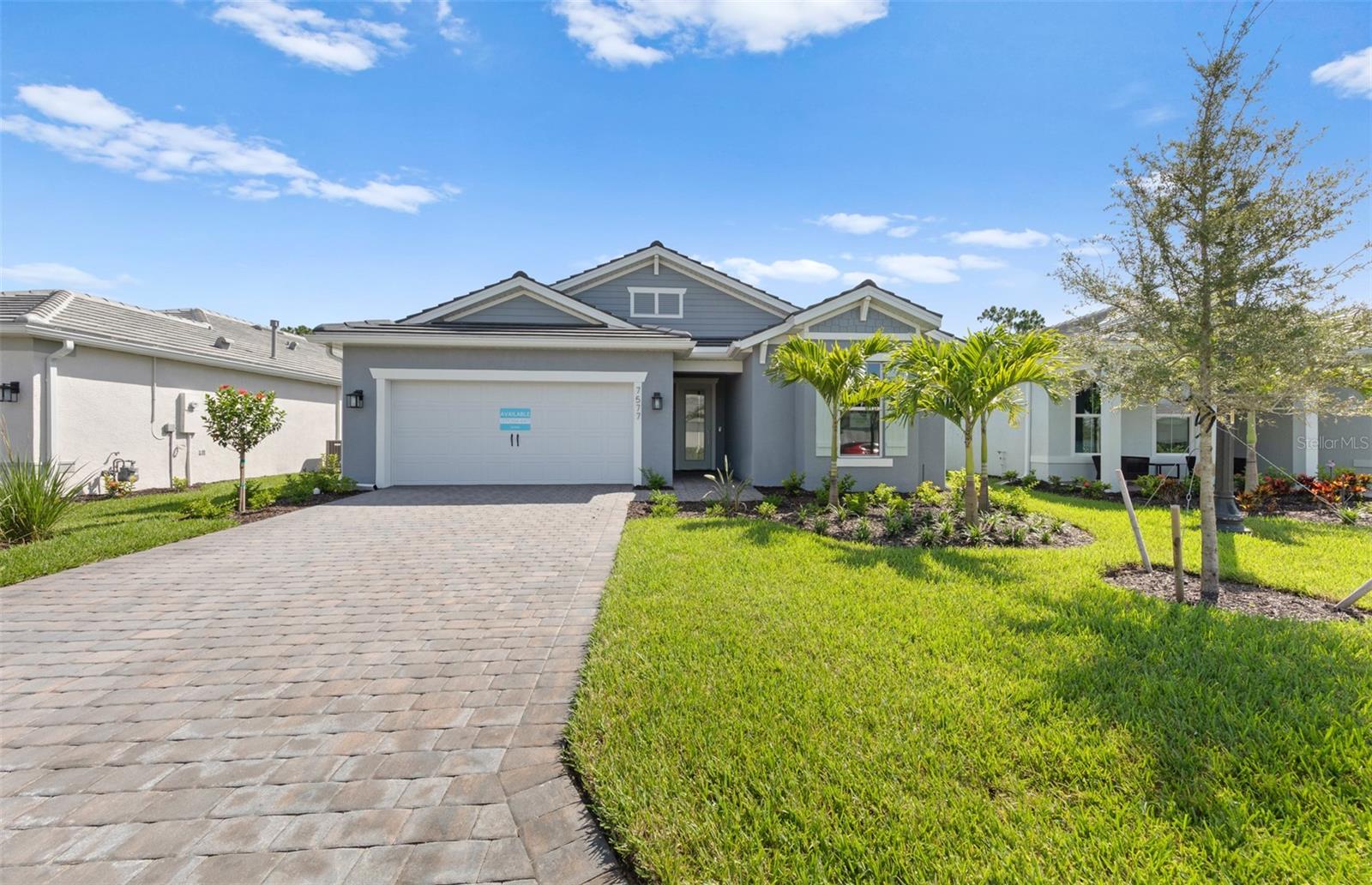 This beautifully crafted Palmary floor plan offers 3 bedrooms, 2 baths, and a 2-car garage, nestled in a brand new boutique style community. This home features an open floor plan with porcelain tile flooring throughout, impact-resistant doors and windows, a tray ceiling in the gathering room and a tankless water heater. The kitchen is a chef’s delight with gas cooking, a built-in microwave/wall oven combo with white cabinetry and contrasting Admiral blue center island with Silestone countertops. Other features include an enlarged shower in the owner's bedroom, upgraded laundry rm w/sink and cabinetry, spacious screened lanai and washer/dryer/fridge are included! Relaxation is easy at the community pool and cabana area while cooking at the BBQ grill area. Don't miss this opportunity to own a brand-new home with designer finishes! Photos are from a furnished model. Options for this home may vary.