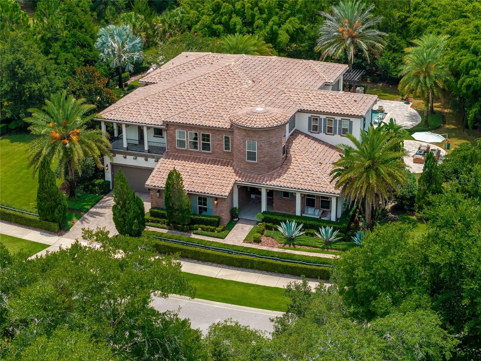 Incredible once-in-a-lifetime opportunity to purchase this gorgeous estate home with over 800k in upgrades and exquisite finishes on a nearly 3/4 acre resort-like lot in the Markham Woods Corridor! This breathtaking home was the model and every inch of it was meticulously and luxuriously finished by the renowned Marc-Michaels Interior Design firm. You'll find unparalleled, top-of-the-line opulence around every corner of this exceptional retreat. The transitional design and open & airy floor plan features blond oak woods floors and transom windows throughout the downstairs. You'll find an office, en-suite bedroom, formal and casual dining rooms & club room/game room on the 1st floor. The 2nd floor includes the primary suite, loft, theater room, rotunda room and 3 additional roomy bedrooms. You'll appreciate the unique front exterior design including a wrap around balcony and distinctive brick turret. The stunning foyer has sky high ceilings and a herringbone pattern in the beautiful oak floors. Just off the foyer is a handsome office with wood beamed ceilings and built-in shelving. Also adjacent is a comfortable downstairs bedroom with shiplap walls, a walk-in closet and en-suite bath. The awe-inspiring great room is lined with a wall of sliders and windows and an impressive floor-to-ceiling stone fireplace. The elegant dining room is built for entertaining and features wood beams, stylish built-in buffet and butlers pantry leading into the kitchen and has a stylish built-in bar and wine cellar nearby. The phenomenal kitchen features an expansive quartz island and sprawling counter space, Sub-Zero and Wolf appliances, including THREE ovens, one a built in with a warming drawer beneath it, two more within the stove. The stove features six gas burners and a built-in grill for the cooking aficionado. There is a stunning, light and bright casual dining area just off the kitchen. Adjacent to the great room, you'll find a dramatic club room with floor-to ceiling-windows (currently being used as a playroom) that could be used for a multitude of purposes. Up the majestic staircase, you'll find an attractive loft with built-in cabinetry. The stunning primary suite includes a wet bar and an impressive balcony overlooking the gorgeous yard. Relax and unwind in the unbelievable primary bath, which has two built-out walk-in closets, dual vanities with oodles of storage, a huge soaking tub and expansive walk-in shower. The striking theater room includes cozy, multi-level seating, built-in cabinets and includes all furniture and equipment. Each of the 3 secondary bedrooms upstairs are generous in size and all include walk-in closets, one with an impressive rotunda room off of it and one that connects to the wrap-around balcony. The incredible and ultra-private backyard is the focal point of this amazing home! There are multiple seating areas for relaxing and entertaining. The spacious covered porch includes tongue & groove ceilings and motorized screens for protection from the elements. The amazing saltwater pool features an in-ground seating area perfect for a fire pit and has a gorgeous in-ground spa framed by a dramatic pergola. You'll also find a fully-equipped outdoor kitchen, with a built-in breakfast bar with generous seating. Beyond the pool area are a multitude of beautiful & unique trees, plants and plenty of open yard for recreation. Located just off the walking trail and minutes from all the wonderful amenities that the area has to offer!