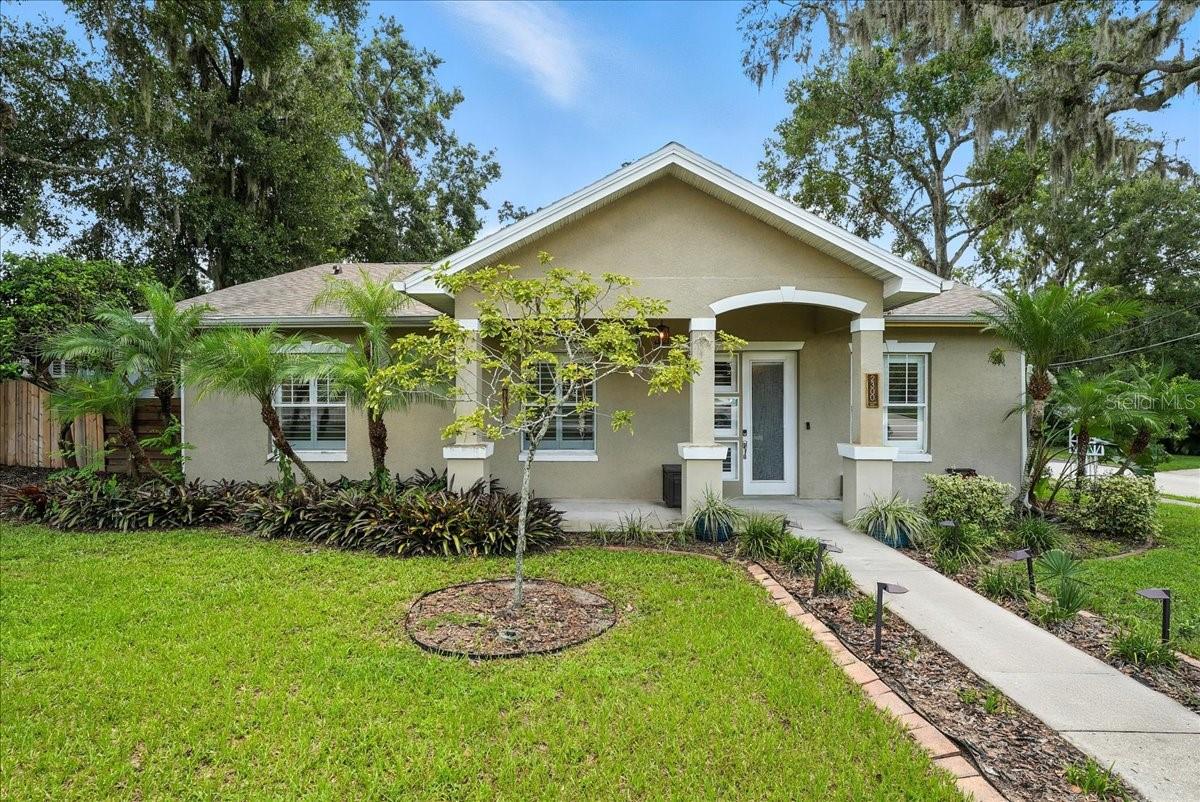 This beautiful 4 bedroom, 3 bathroom home located in Orlando’s sought-after Lawsona Fern Creek neighborhood offers classic Florida living just minutes from the heart of downtown. Nestled on an oversized 0.24 acre corner lot, this residence welcomes you with a charming walkway and lovely landscaping framed by mature oak trees that create a peaceful, shaded retreat. Inside, a well-designed spacious floor plan provides functionality with the bright living areas highlighted by gorgeous flooring and large windows that flood the space with natural light. The family room offers a cozy setting for relaxing or entertaining. Throughout the home, you’ll find thoughtful details including crown molding, speakers, and spacious closets. The kitchen features solid wood cabinetry, stainless steel appliances, and a large breakfast bar that opens into the adjoining dining area, perfect for everything from casual breakfasts to hosting friends and family. Just beyond, enter through the French doors to a tranquil backyard escape, complete with an expansive patio, planters, and a firepit, ideal for outdoor entertainment or weekend lounging. Additional highlights include a wonderful primary suite with a walk-in closet and luxurious bathroom with dual sink vanity, walk-in shower and tub, a custom laundry room with an abundance of cabinet space, a 2 car garage with a work station and additional storage, and a fenced yard for privacy. Located just blocks from Lake Lawsona, the Milk District, and Thornton Park’s vibrant dining and shopping scene, and zoned for desirable schools, this home offers the perfect blend of convenience and residential charm in one of Orlando’s most beloved neighborhoods.