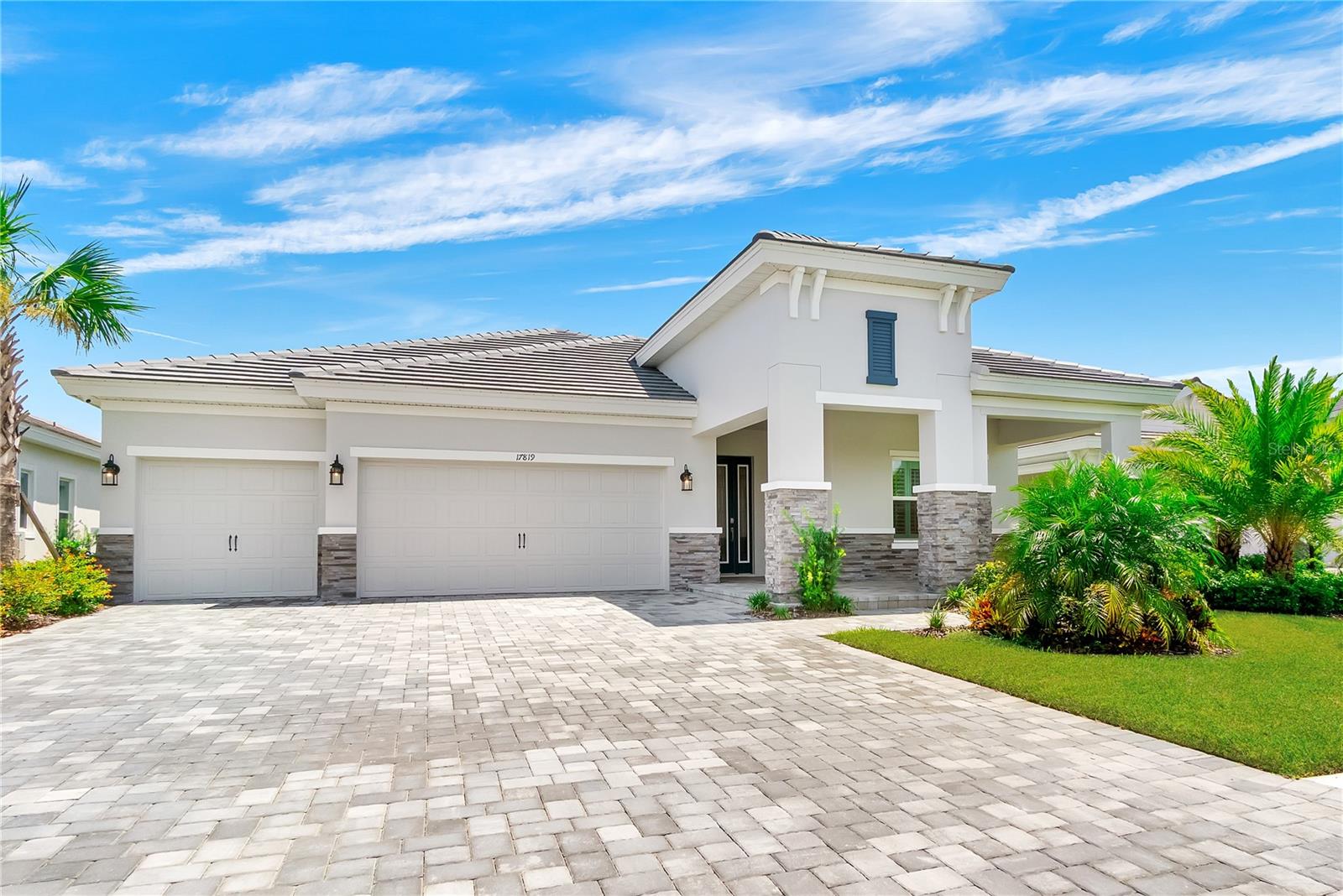 Why wait to build when this better-than-new 2024 Biscayne I by Homes by WestBay is ready now—complete with over $400,000 in designer upgrades and a custom backyard pool/spa oasis?
This exceptional home offers 3 bedrooms plus a den, 3 full bathrooms, and a 3-car garage, blending modern luxury with thoughtful design for every stage of life. It is perfect for those who love to entertain, relax in style, and embrace the best of the Lakewood Ranch lifestyle in the amenity-packed community of Star Farms.
From the moment you enter, soaring 12-foot ceilings, elegant wood beams, and abundant natural light set an inviting tone. The arched hallway adds charm and leads to two spacious guest rooms at the front of the home, along with a versatile double glass-door den—ideal for a home office, gym, or hobby space.
The upgraded chef’s KITCHEN is a true showstopper. It features a Calacatta Bali Quartz island with wraparound storage and an extended dining counter, custom soft-close cabinetry with upper glass-lit display cabinets, a built-in coffee and wine bar, a designer hood with full backsplash to the ceiling, and upgraded appliances.
The GREAT ROOM is a masterpiece, with 24 ft. of continuous sliders seamlessly connecting the indoors to the lanai and natural Florida sunshine. Wood beams overhead add architectural elegance. There is room for a sizeable dining table alongside the kitchen, in addition to the casual seating space at the island.
The PRIMARY owner’s suite offers a serene escape with an oversized custom walk-in closet, spa-like bath with walk-in shower and built-in bench, dual vanities, and a dedicated makeup station. A private door opens directly to the lanai, where the true highlight of this home awaits.
The OUTDOOR LIVING space is designed for year-round enjoyment, with an extended covered lanai, a full outdoor kitchen, and a stunning custom heated pool featuring a sun shelf, in-water benches, and a raised spa. Expansive water views provide the perfect backdrop to this stunning outdoor space!
Additional upgrades include IMPACT GLASS throughout, EPOXY finished garage floors, LUXURY VINYL plank flooring, a whole-home WATER SOFTENER, plantation SHUTTERS, custom LIGHTING and ceiling fans, BUILT-IN SPEAKERS, and 8 FOOT DOORS for an elevated feel in every room. And don't miss the well-appointed Laundry Room with additional CABINET STORAGE, sink, and beautiful tile backsplash.
Beyond your front door, the gated community of STAR FARMS offers something for every age and lifestyle. THREE AMENITY CENTERS provide resort-style pools, fitness centers, sports courts, and walking trails. Residents can enjoy the new PALM BAR for cocktails and a bite by the pool or grab a morning latte at the on-site Trade Route Coffee Shop.
The neighborhood is conveniently located near a new Publix plaza, top-rated schools including the brand-new Lake Manatee K-8 School, Manatee and Sarasota beaches, and all that Lakewood Ranch has to offer.
Living in Lakewood Ranch means more than just owning a beautiful home—it is award-winning, master-planned living just minutes from Gulf Coast beaches, downtown Sarasota, world-class sports facilities, and endless shopping and dining.
Schedule your private showing today and start living your Florida dream in Star Farms at Lakewood Ranch.