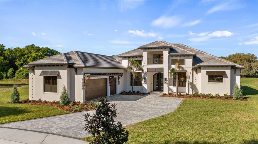 Welcome to luxury living in the prestigious Red Tail Golf Club community of Sorrento, Florida—an upscale, gated golf neighborhood known for its elegance, privacy, and prime location. Conveniently situated near both Lake and Orange Counties and just minutes from the State Road 429, this home offers seamless access to downtown Orlando, area attractions, and everything Central Florida has to offer. Situated on a private cul-de-sac with breathtaking golf course views, this custom-crafted Windsor Cay estate offers over 4,100 square feet of living space and nearly 6,000 total square feet under roof, blending sophistication, innovation, and comfort.

From the moment you arrive, you’re welcomed by a stunning 10-foot custom iron and glass front entry door system, Miami-Dade County approved for superior wind load performance. Inside, soaring ceilings and expansive 10-foot sliding glass doors in the great room create a seamless indoor-outdoor living experience.
This thoughtfully designed home features: 

5 Bedrooms | 4.5 Bathrooms | 3-Car Garage with smart Wi-Fi garage door opener, Private Study + Flex Room (ideal for gym, library, or hobby space) Designer lighting package with curated fixtures throughout, Architectural beam details and a striking linear electric fireplace with stone surround.

The gourmet chef’s kitchen is a true showpiece, featuring Premium Fisher & Paykel smart Wi-Fi appliance package. Built-in coffee maker, including Expresso, large warming drawer, and wine refrigerator and a beautiful Custom Venetian plaster vent hood. The huge Hidden walk-in pantry with occupancy sensor lights, provides an additional sink, freezer drawers cabinetry, and space for countertop appliances. 
Exquisite quartz countertops throughout. 
The primary suite delivers a spa-like retreat with Moen Wi-Fi enabled smart shower controls, allowing you to preset temperature and start your shower from your phone. All bathrooms are equipped with smart toilets and premium finishes. 
Step outside to your private resort!
Custom pool and spa with waterfall feature, fire bowls, sun shelf with glass tile mosaic, and negative edge spa. Full Wi-Fi automation for pool, spa, lighting, and water features. Expansive outdoor living area with a fully equipped summer kitchen featuring a 36" DCS Grill, with rotisserie, burners, hood, sink, refrigerator and Private putting green for your entertainment.  Professionally designed landscaping with elegant exterior lighting for enhanced curb appeal and nighttime ambiance

Additional highlights include a spacious laundry room with extensive cabinetry and upgraded storage solutions.

Offered at $2,319,000, this exceptional residence combines cutting-edge smart home technology, luxury finishes, and timeless design—all within one of Central Florida’s most desirable golf communities.