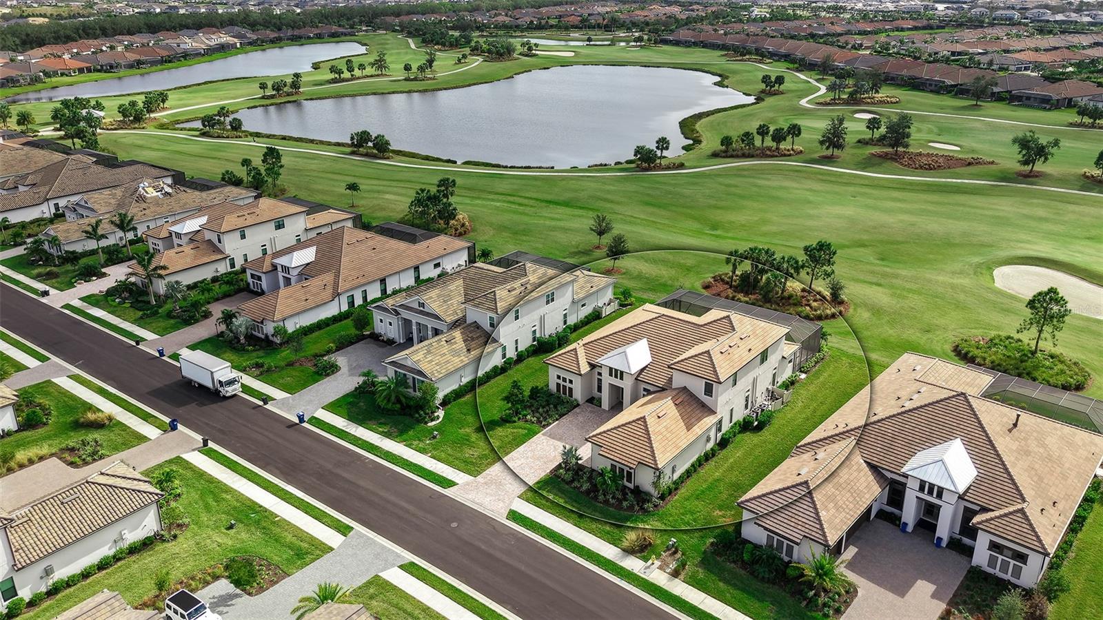 One or more photo(s) has been virtually staged. Welcome to Esplanade at Azario; Taylor Morrison's most recent area luxury resort and golf community. This incredible barely lived-in Beacon model has a stunning golf course view from the sunset friendly lanai and pool. From the impressive paver driveway, you approach the double door entry which opens to a magnificent great room/kitchen which overlooks the pool and golf course. The 12-foot tray ceilings and level 6 tile flooring create a sense of modern elegance. The gourmet chef's kitchen has upgraded quartz counter tops with a glass tile back splash, stainless appliances, lighted designer wood cabinets and crown molding. There is a pass through to the formal dining room. Full wall sliders create inside/outside Florida style living. The panoramic pool screen allows for unobstructed views. The large lanai with an outdoor kitchen, heated pool and spa provides a great space for entertaining or a private oasis overlooking the golf course.
The first floor also has a private office and 3 bedrooms with ensuite bathrooms. The primary bathroom has dual sized showers with frameless doors, upgraded tile and quartz counter tops, double sinks, and walk-in-closets. There is also a powder room bath on the first floor. There is a large laundry room with upper and lower cabinets and in the nearby hall there is a drop area as you enter from the garage.
The upstairs bonus room is an ideal space as a TV room, game room, large office, gym, or playroom. There is a wet bar with a dishwasher, microwave, and undercounter beverage refrigerator. There is a fourth bedroom and full and half bath as well.
his home is built with comfort and security in mind. There is a 3 zone HVAC system, tankless water heater, hurricane windows on the front of the home and shutters in back, lawn irrigation, in-wall pest control, and maintenance free resort living. The Azario community is gated.
This is a golf deeded lot and the quarterly fee covers the Golf Membership for the 18-hole championship golf course, an aqua driving range, and pro shop. Residents at Azario have access to 16 pickleball courts, bocce ball, and 6 tennis courts. The beautiful clubhouse has a salon, fitness center, spa, meeting rooms, and outside lanai. The huge resort style pool and spa pool are located near the Bahama Tiki bar. The new Culinary Center has formal to casual dining options and a teaching kitchen. A full social calendar of parties and events is planned by the on-site social director. Living at Azario is like being on a permanent vacation!
Please note: Buyers pay a $5000 capital contribution at closing. Measurements are approximate. A floor plan is available. Staging and virtual staging is being used. Ask about furniture that can be purchased.