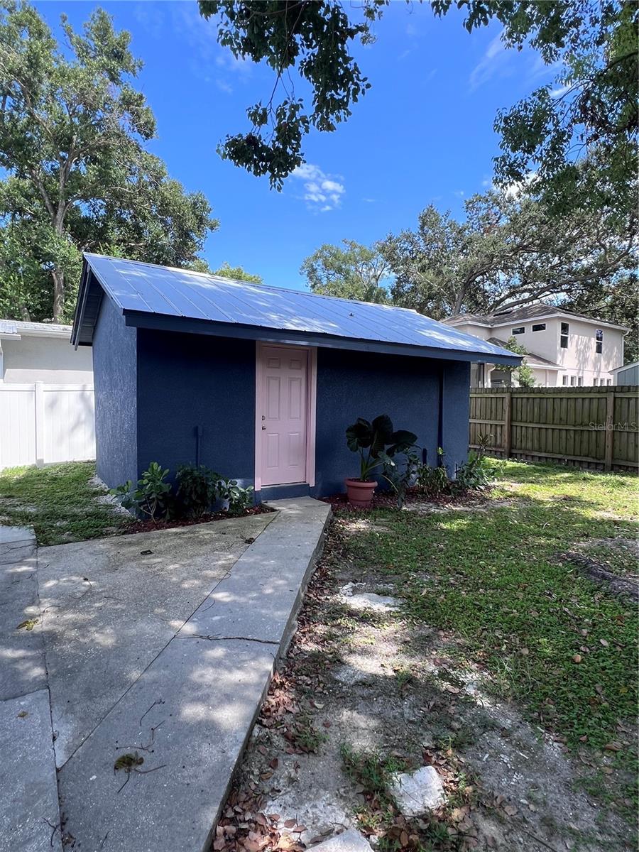 Looking for the perfect crash pad in one of Tampa’s most vibrant neighborhoods? This modern 429 sq. ft. detached suite has everything you need wrapped up in a stylish little package. The kitchenette shines with quartz countertops, a sleek tile backsplash, portable cooktop, and refrigerator—perfect for whipping up meals at home. A full bathroom with a stand-up shower adds convenience, and the open layout makes the space feel bright and inviting. Best part? Water and electric are included, so you can focus on enjoying life in Seminole Heights—just minutes from trendy coffee shops, foodie-favorite restaurants, local markets, shopping, Downtown Tampa, and major highway access. Whether you’re on the go, new to the area, or just want a cozy space close to all the action, this home is the spot for you! (Not pictured: a brand-new refrigerator, plus the shower will feature a glass frame for a polished finish!)