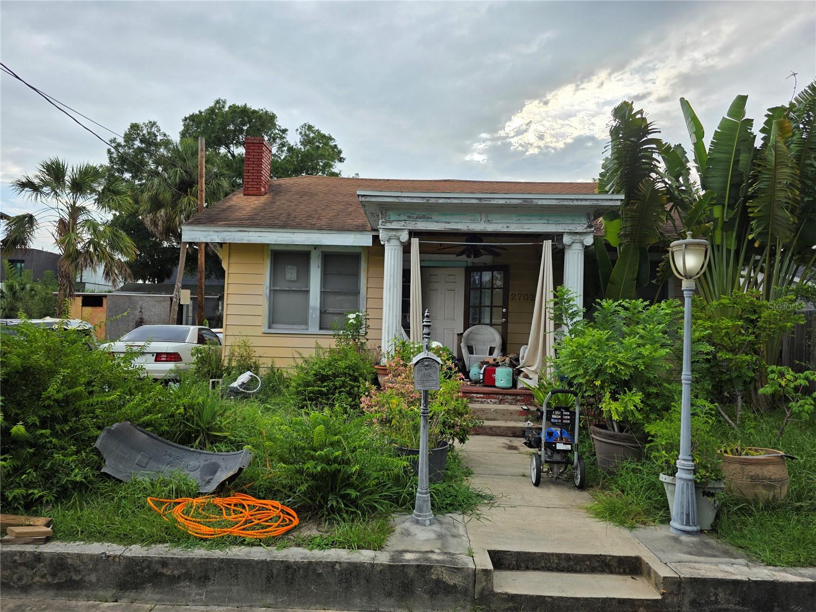 Welcome to this charming 3-bedroom, 1-bath single-family home located in the vibrant and rapidly developing Tampa Heights neighborhood. Built in 1927 and situated on a 6,000 sq ft lot, this residence offers 1,364 sq ft of living space with a traditional layout and original architectural character.
The home features a spacious living area with a fireplace, central heating and cooling, and an open front porch perfect for relaxing. Recent updates include central HVAC and low-maintenance exterior vinyl siding. The detached garage and deep lot provide additional potential for storage or future improvements. Zoned RS-50, this property also offers potential for redevelopment or expansion (subject to city approval).
Conveniently located minutes from Downtown Tampa, Armature Works, the Riverwalk, and major highways, this property combines urban accessibility with neighborhood charm. This is an opportunity perfect for a buyer looking to personalize a home or invest in a high-demand area.
